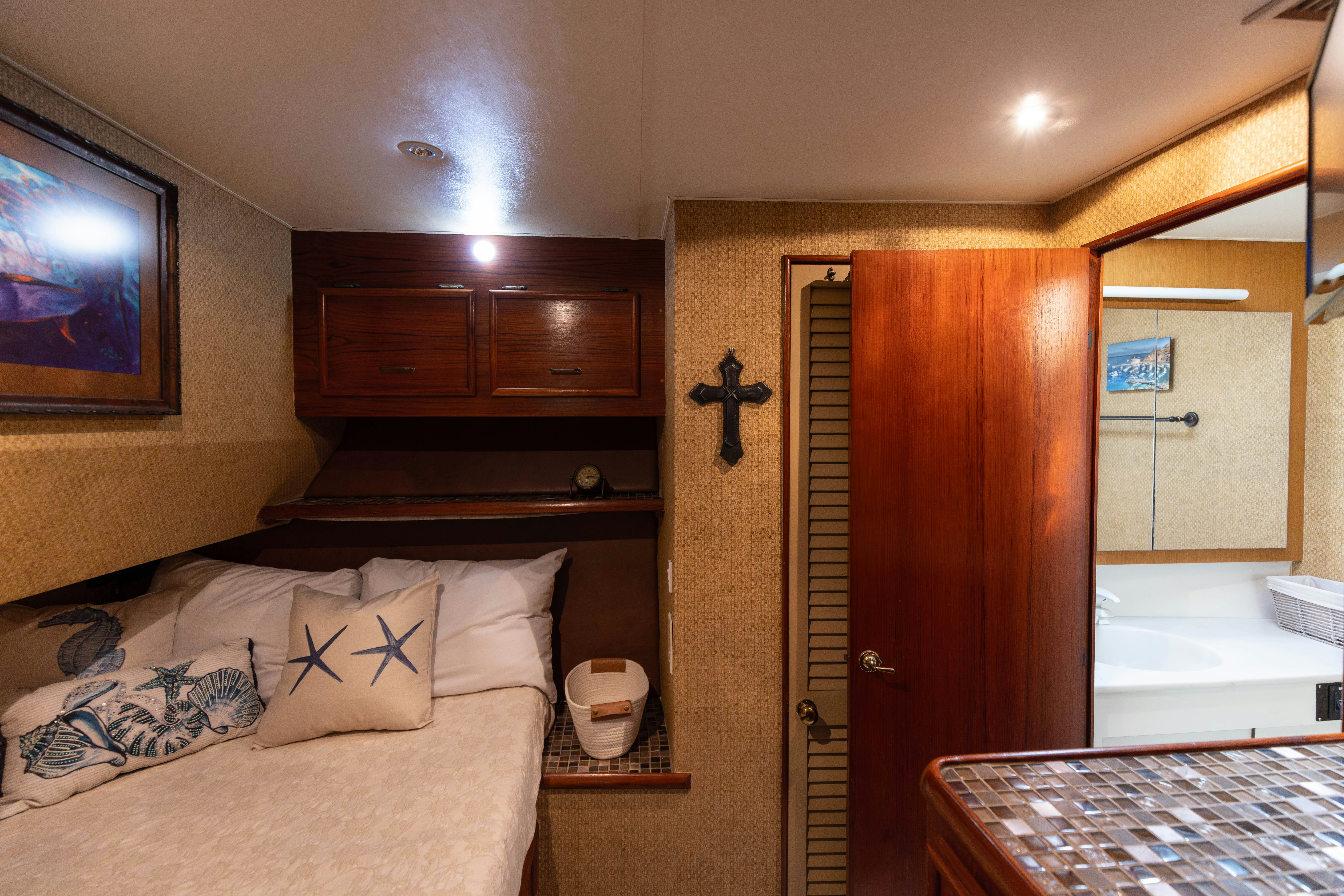 a bedroom with a bed and a mirror aboard LUCKY MARLIN Yacht for Sale