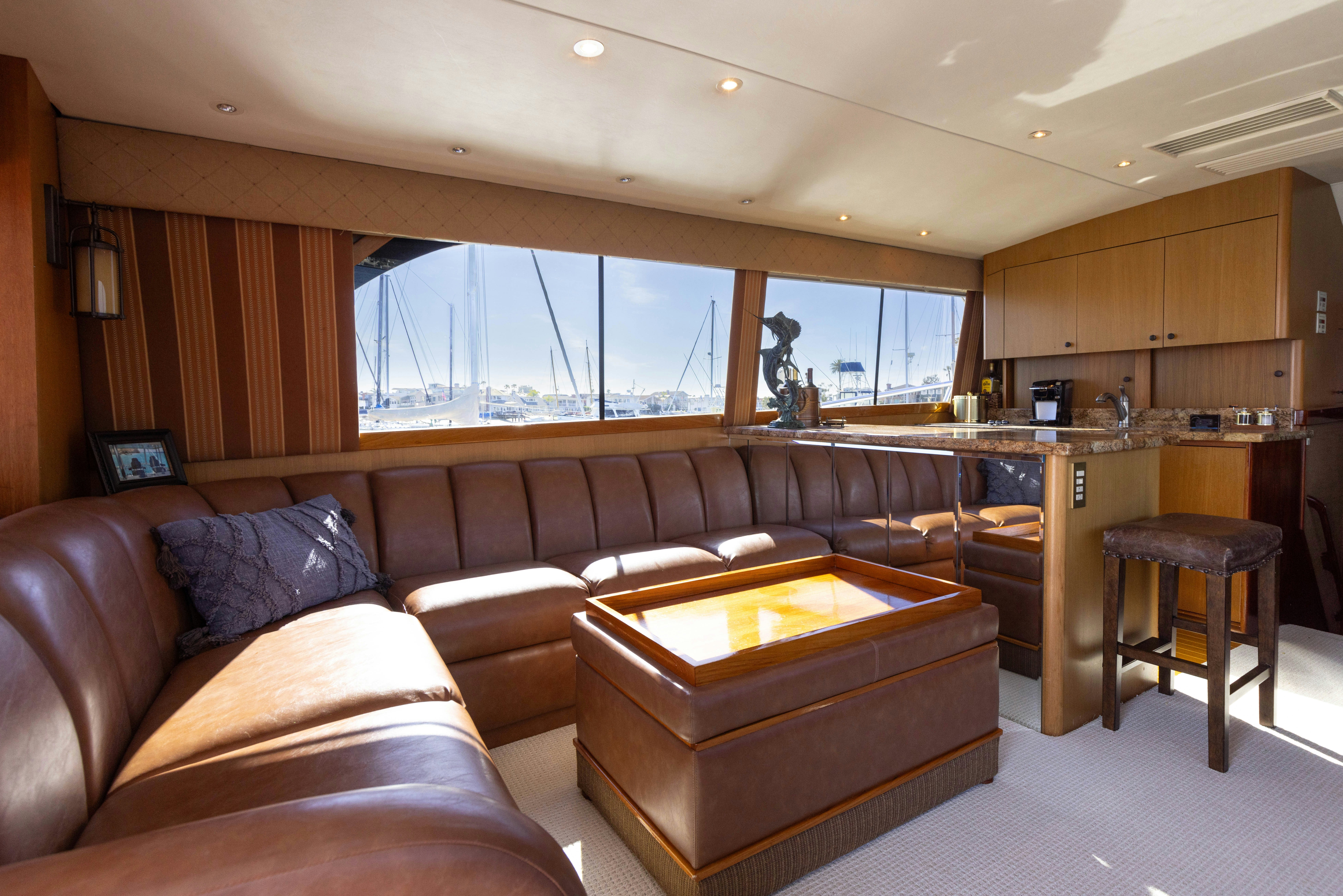 a living room with leather couches aboard LUCKY MARLIN Yacht for Sale