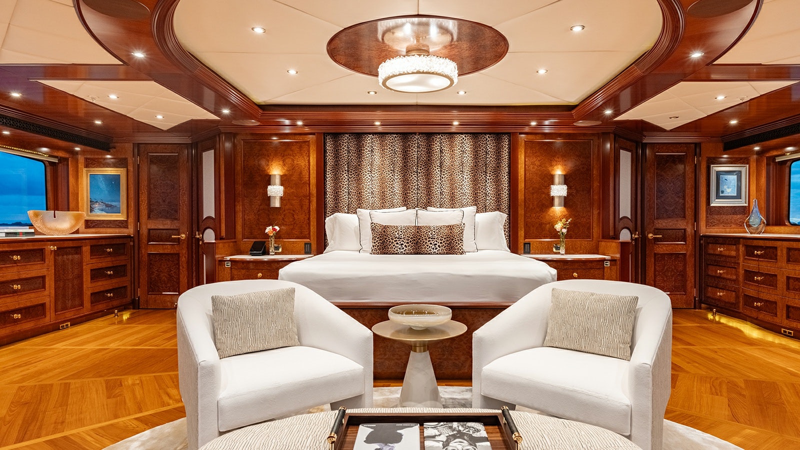 a living room with a large wood cabinet and a white couch aboard IRON BLONDE Yacht for Charter