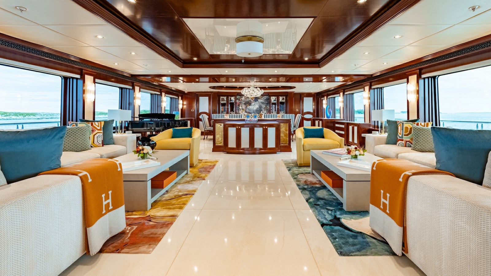 a room with a large bed and a table aboard IRON BLONDE Yacht for Charter