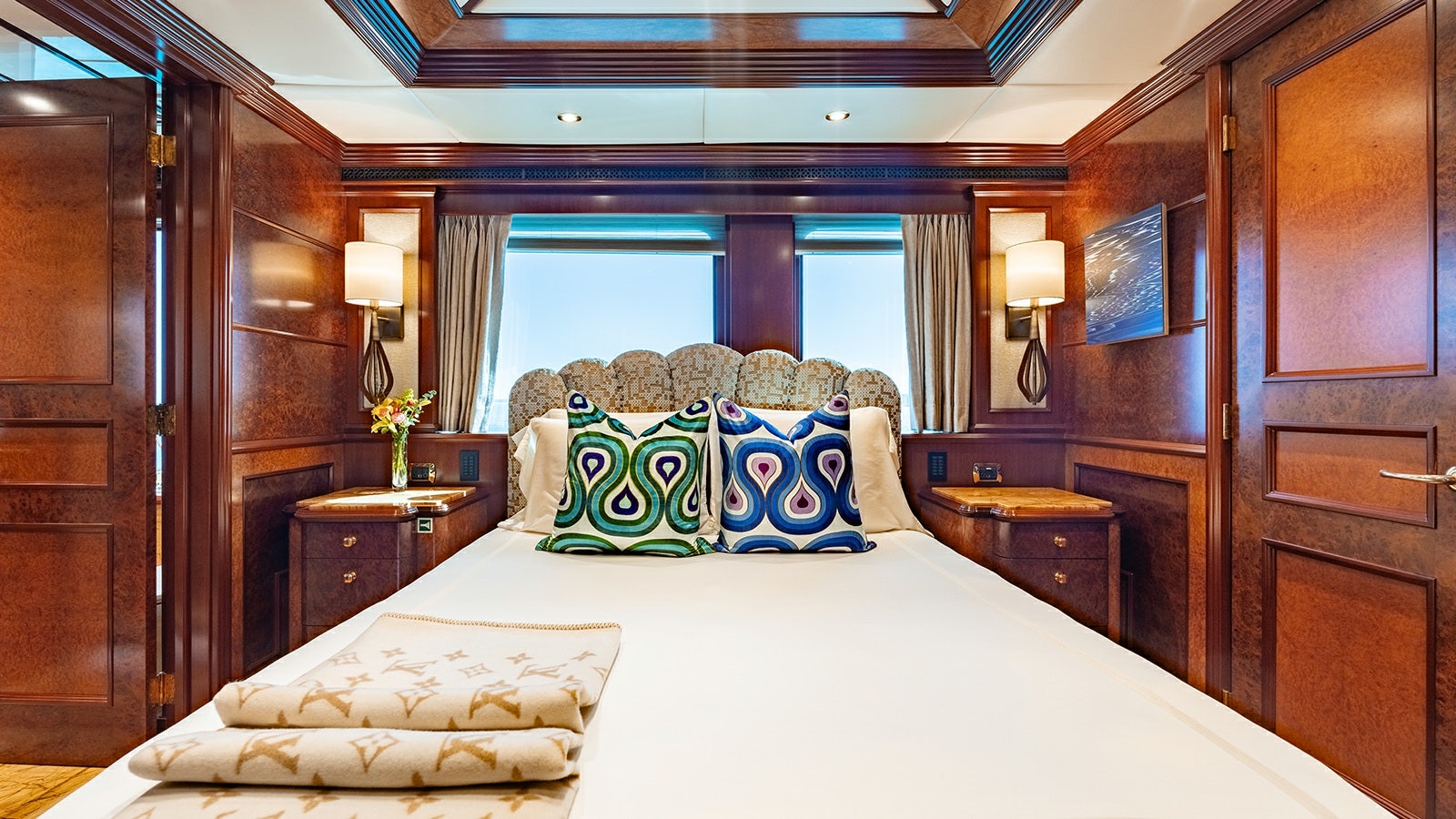 a room with a bed and a desk aboard IRON BLONDE Yacht for Charter