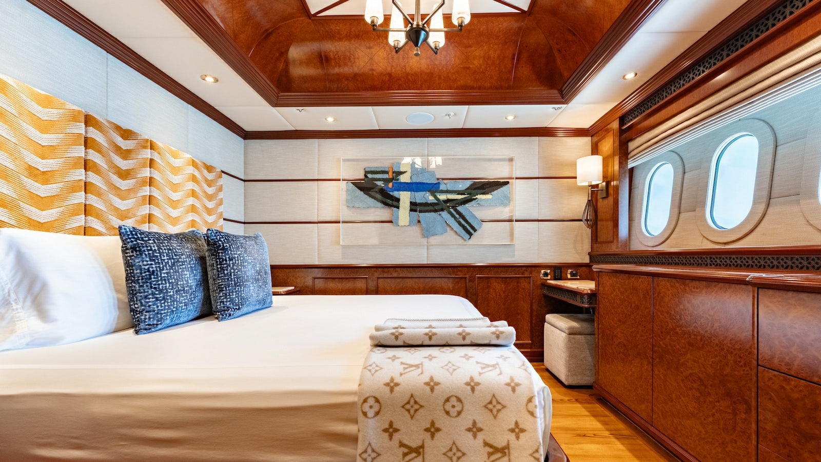 a bedroom with a bed and a mirror aboard IRON BLONDE Yacht for Charter