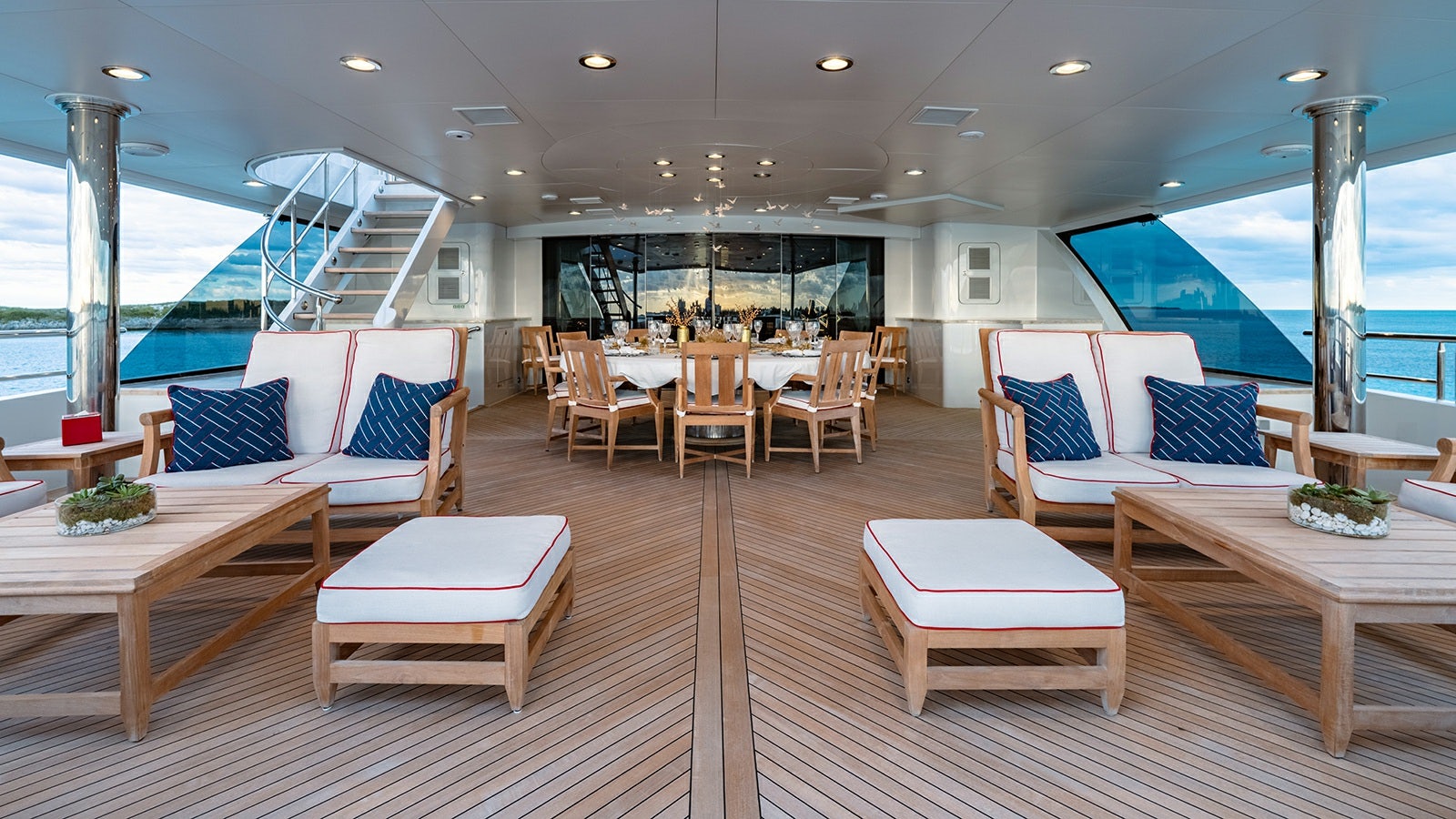 a room with a table chairs and a pool aboard IRON BLONDE Yacht for Charter