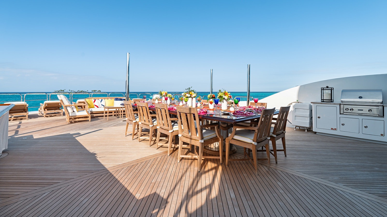 a deck with a table and chairs on it aboard IRON BLONDE Yacht for Charter