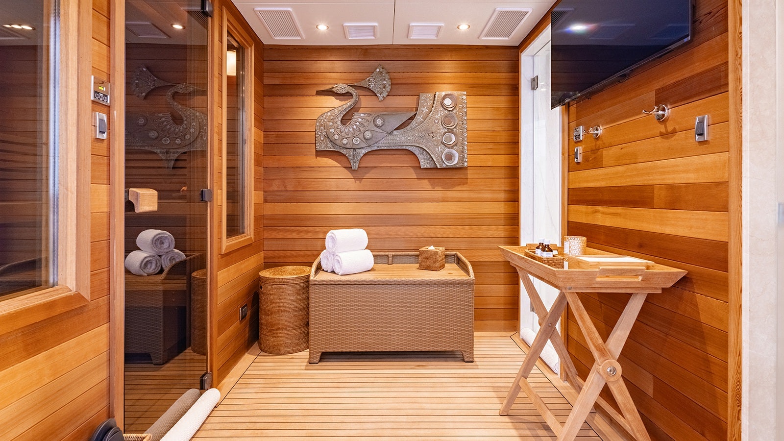 a room with a bed and a table aboard IRON BLONDE Yacht for Charter