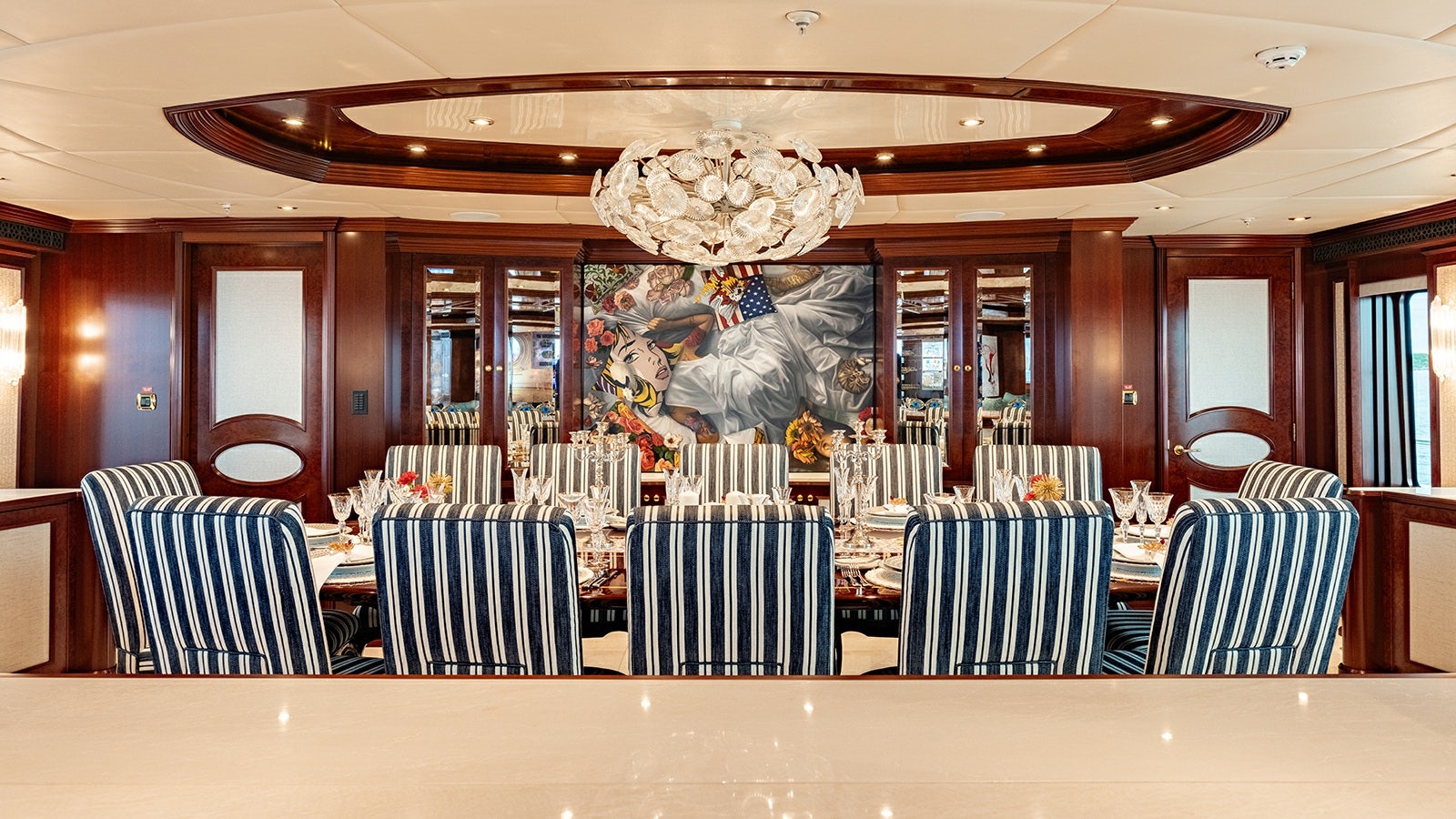 a large room with a chandelier and chairs aboard IRON BLONDE Yacht for Charter