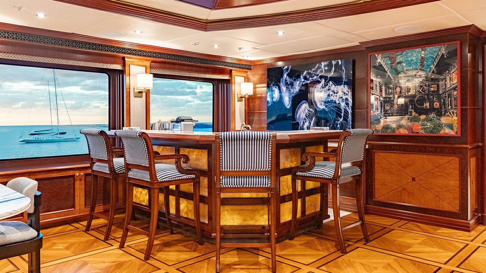 a room with a table chairs and a large window aboard IRON BLONDE Yacht for Charter