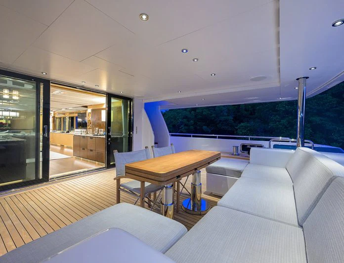 a room with a table and couch aboard TROPA Yacht for Charter