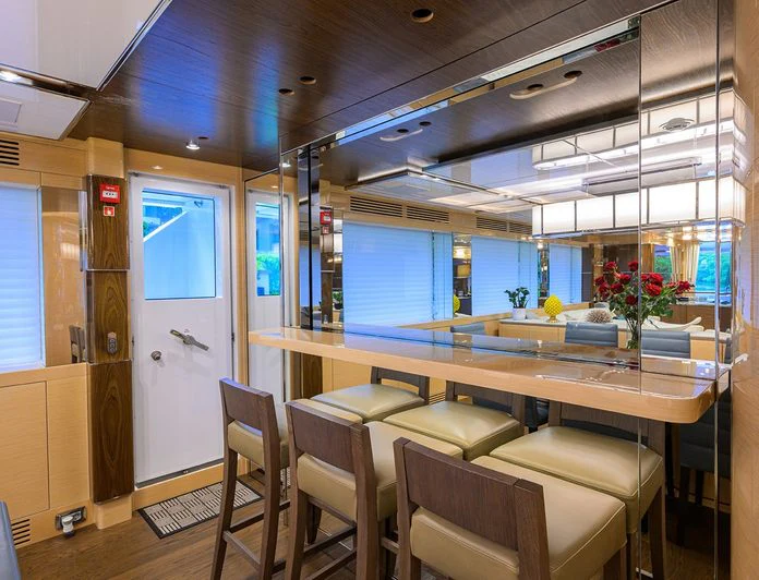 a room with a table and chairs aboard TROPA Yacht for Charter