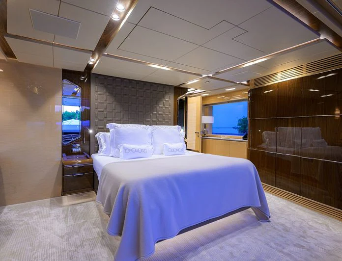 a room with a bed and a tv aboard TROPA Yacht for Charter