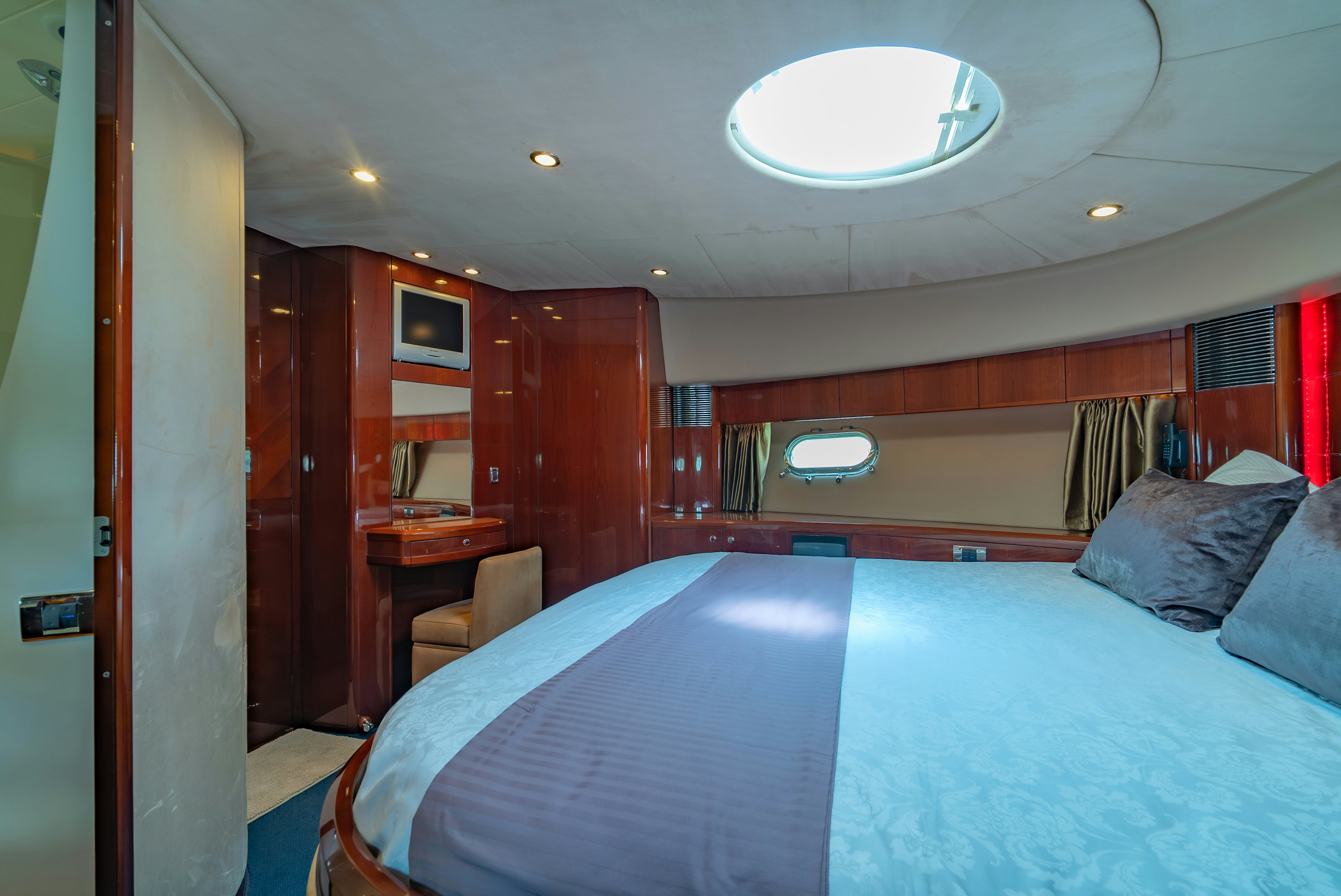 a bedroom with a bed and a desk aboard BLUE ROSE Yacht for Sale