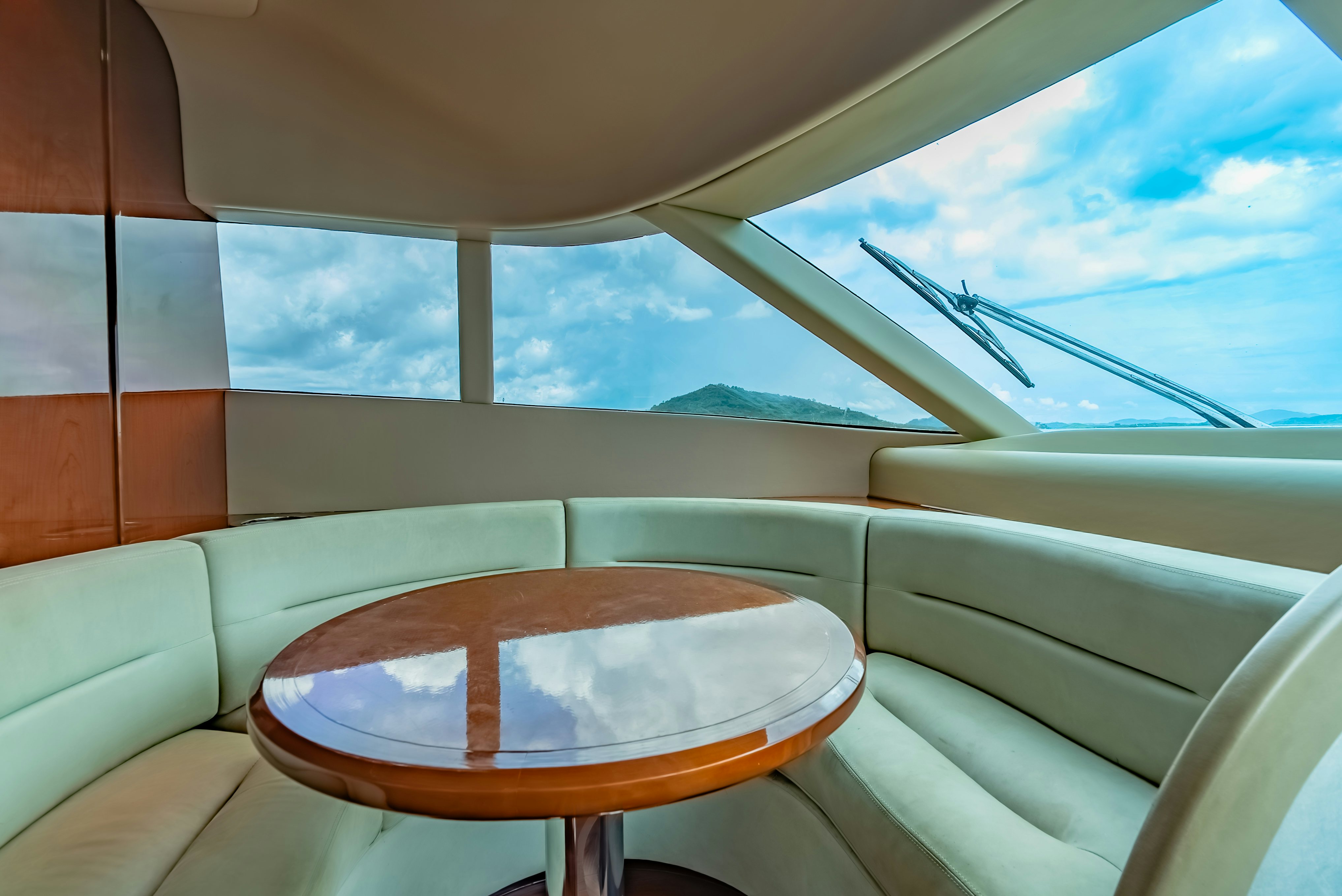 a table and a chair in a room with a view of the ocean aboard BLUE ROSE Yacht for Sale