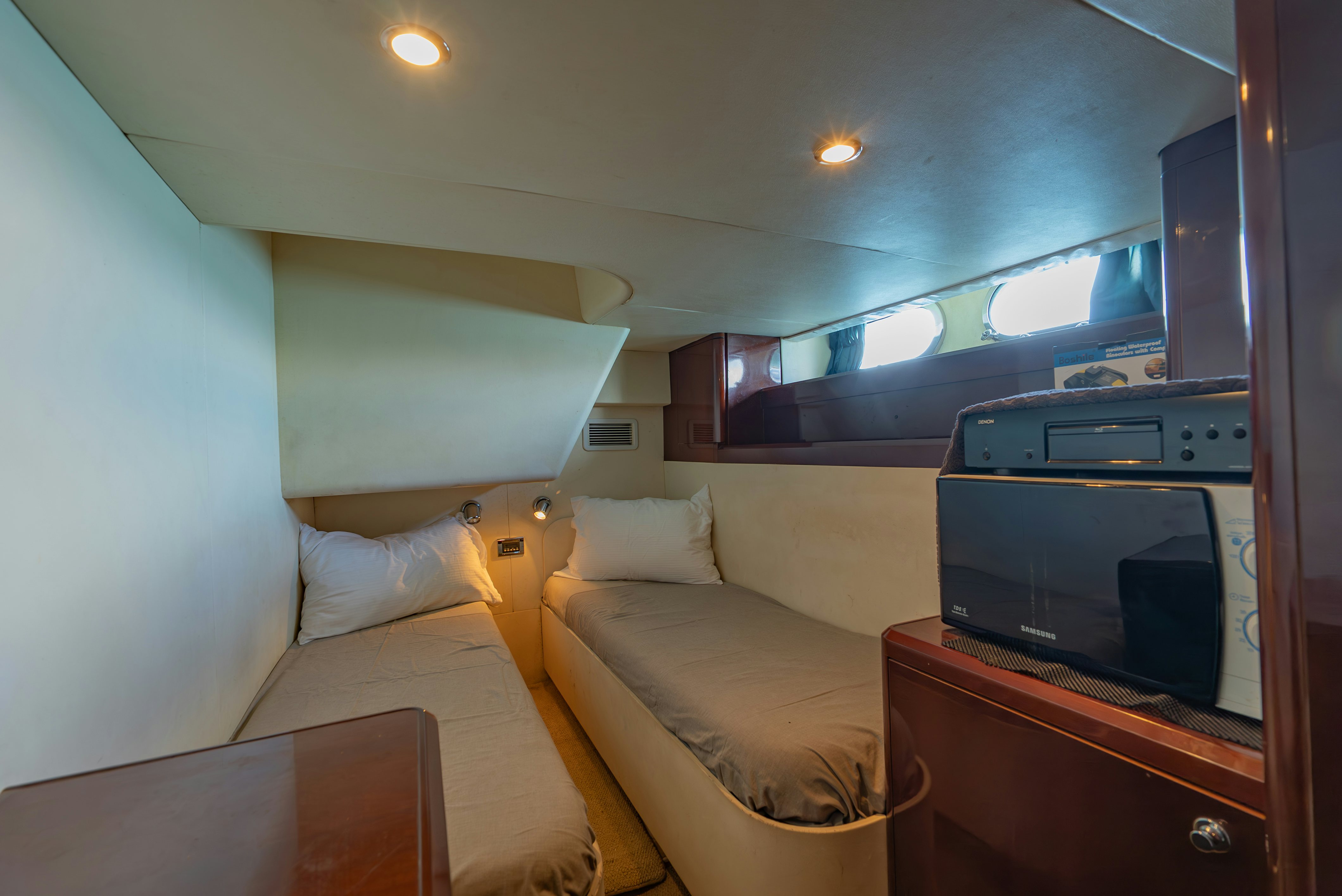 a bedroom with a bed and a television aboard BLUE ROSE Yacht for Sale