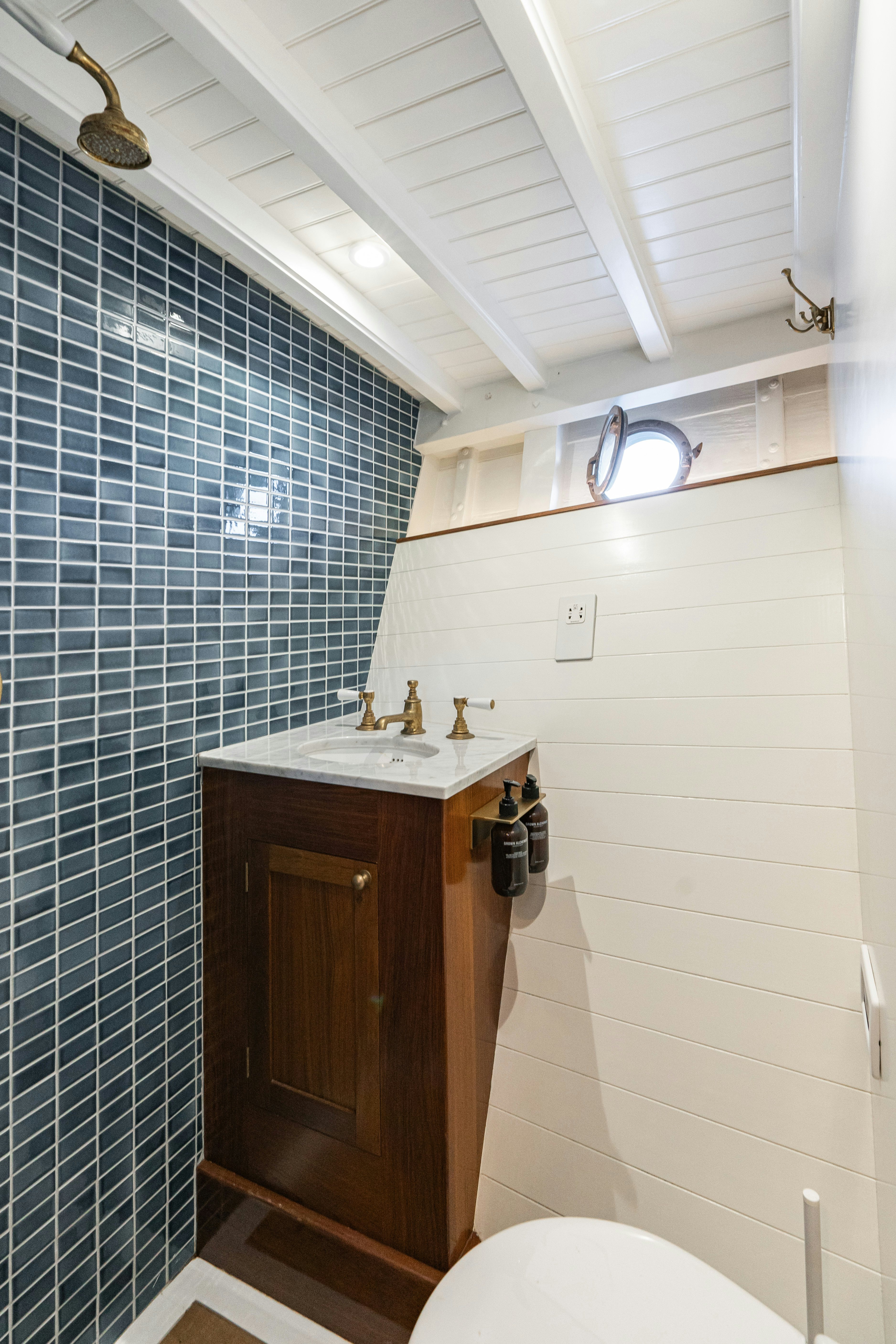 a bathroom with a shower and a sink aboard SILVER LASS Yacht for Sale