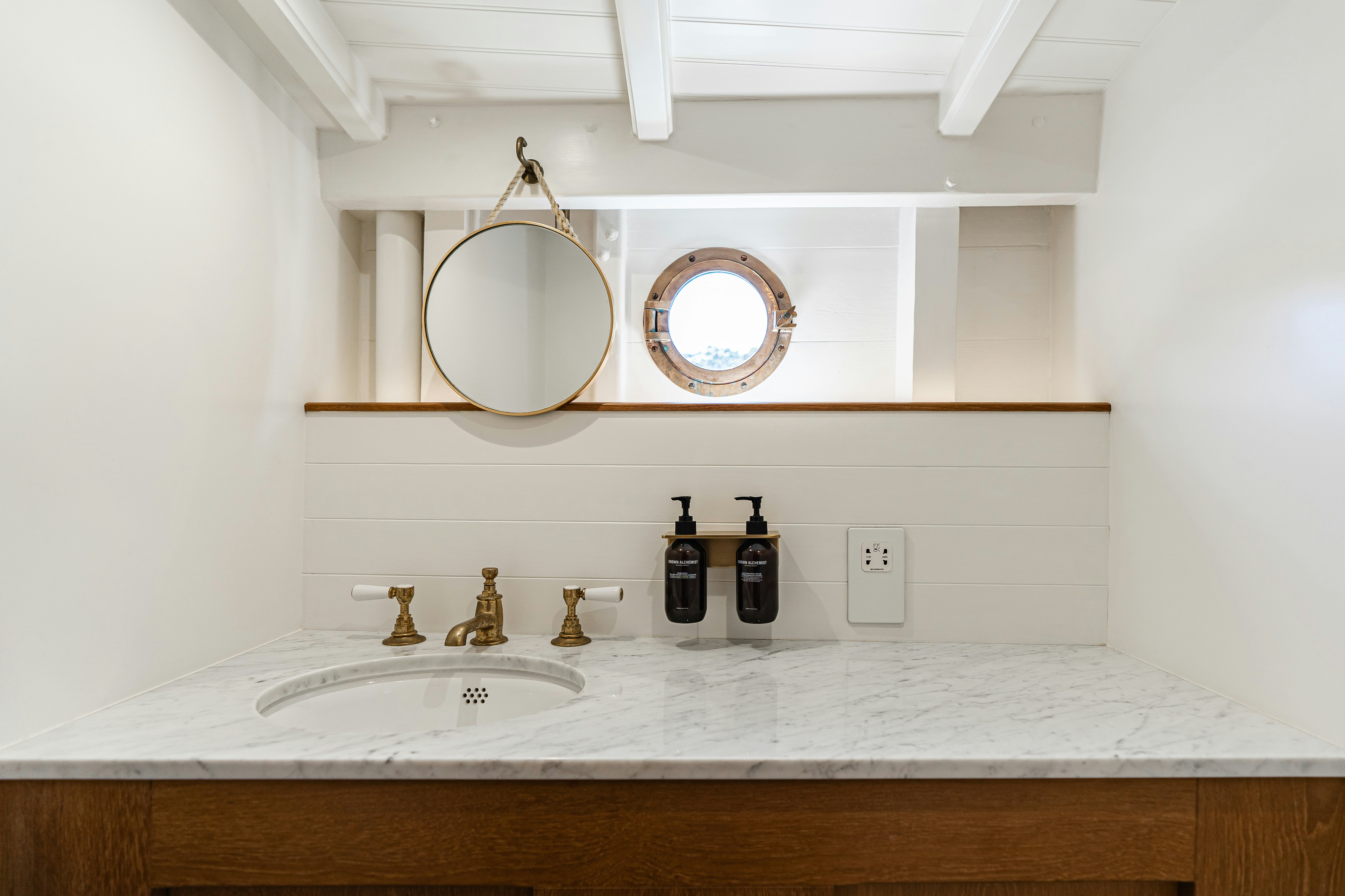 a bathroom with a sink and a mirror aboard SILVER LASS Yacht for Sale