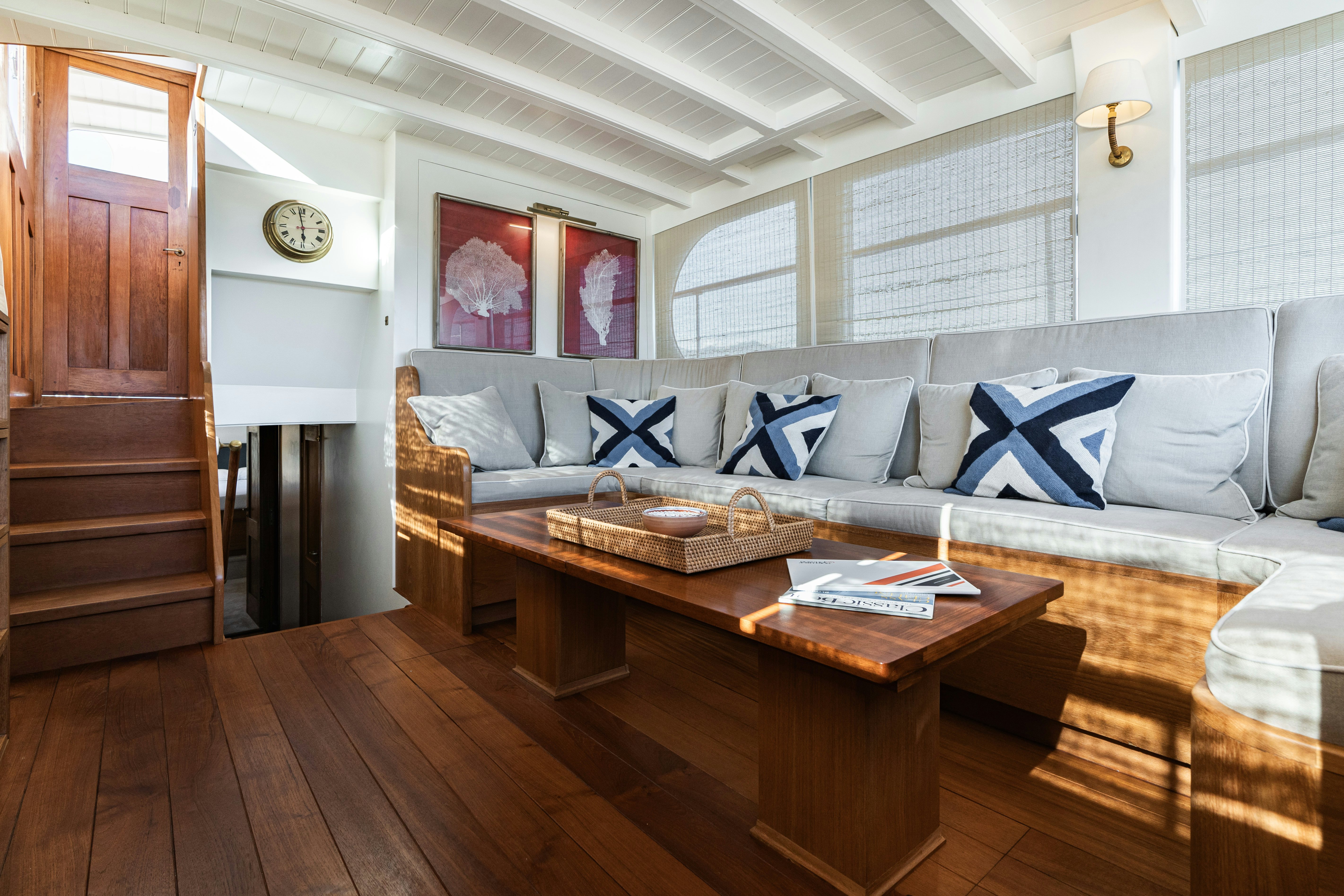 a living room with a couch and a table aboard SILVER LASS Yacht for Sale