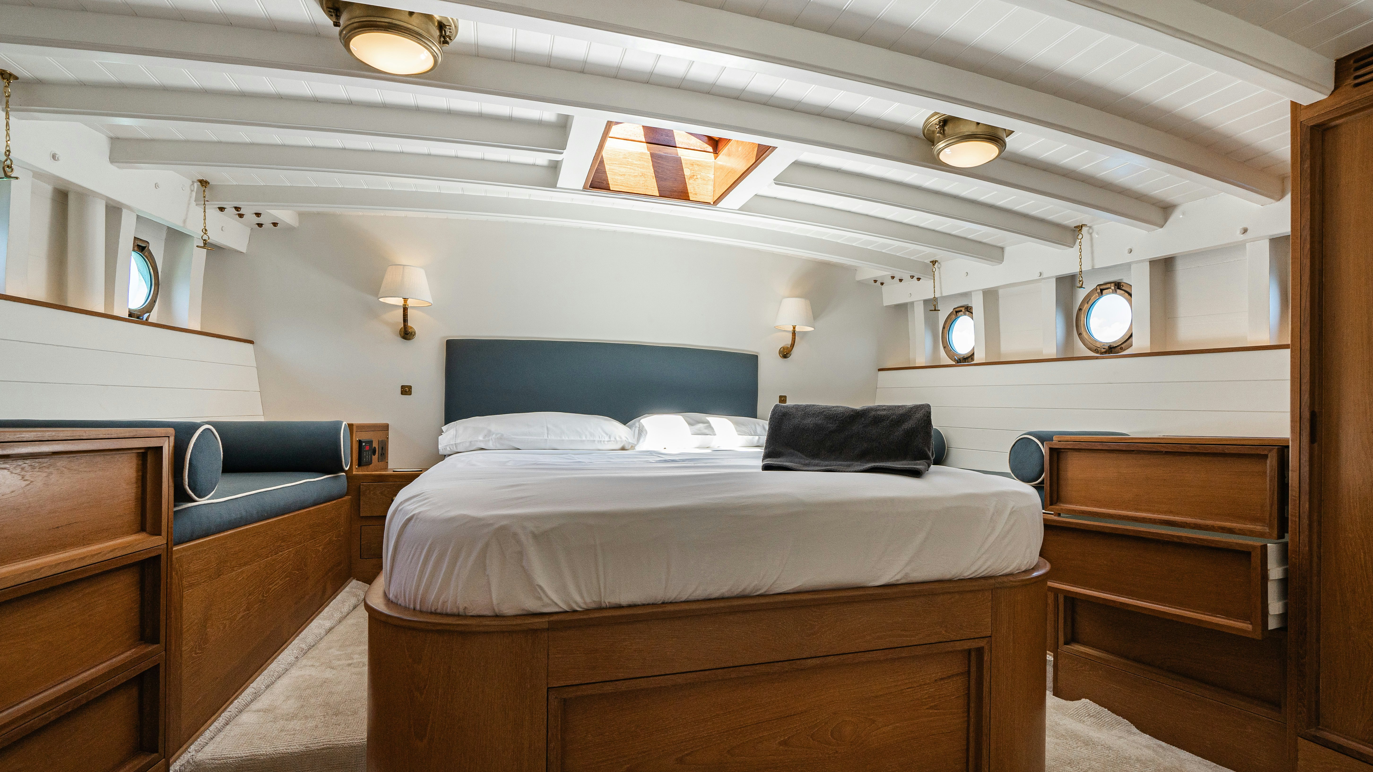 a room with a bed and a dresser aboard SILVER LASS Yacht for Sale