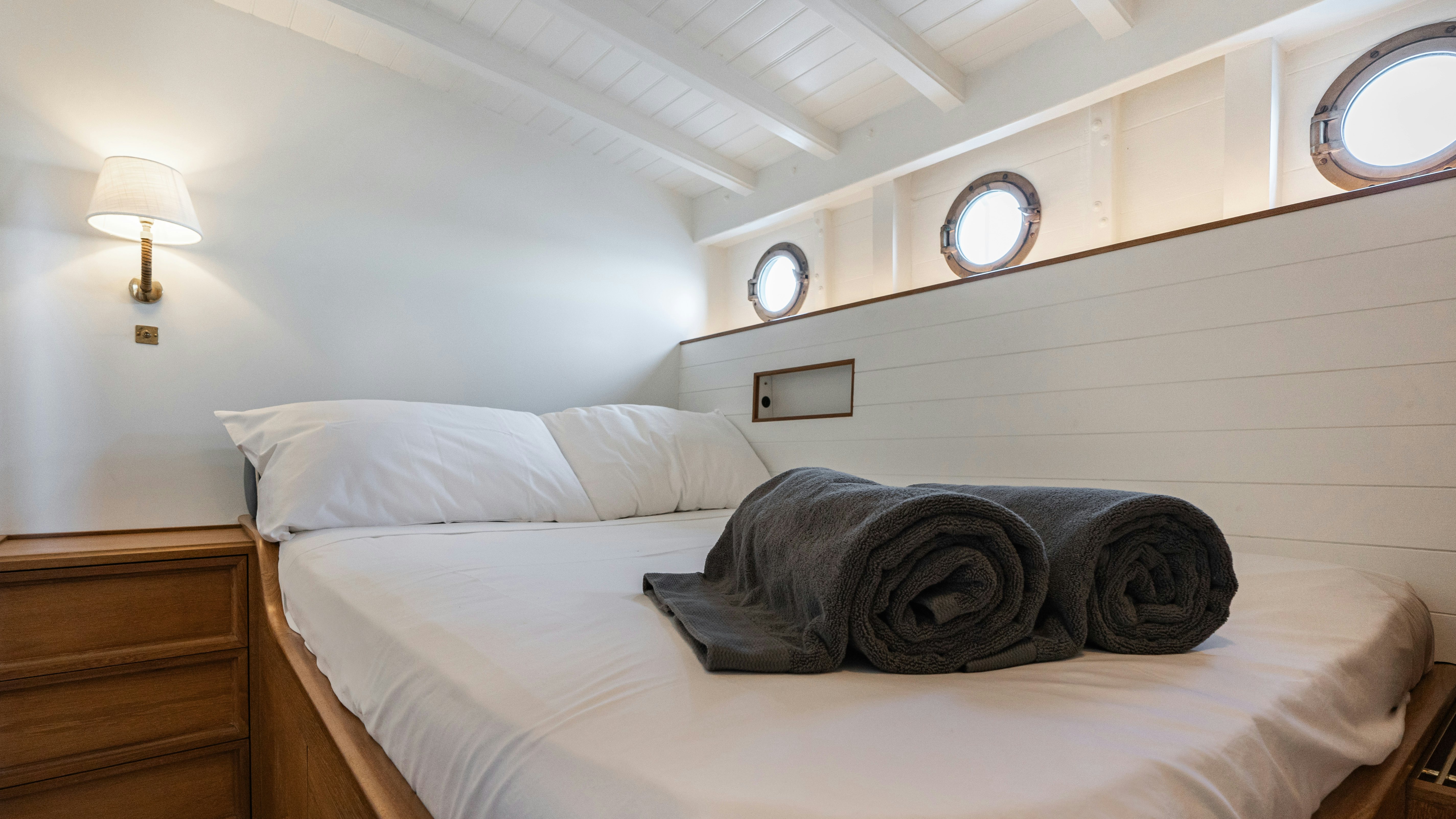 a bed with a white pillow aboard SILVER LASS Yacht for Sale