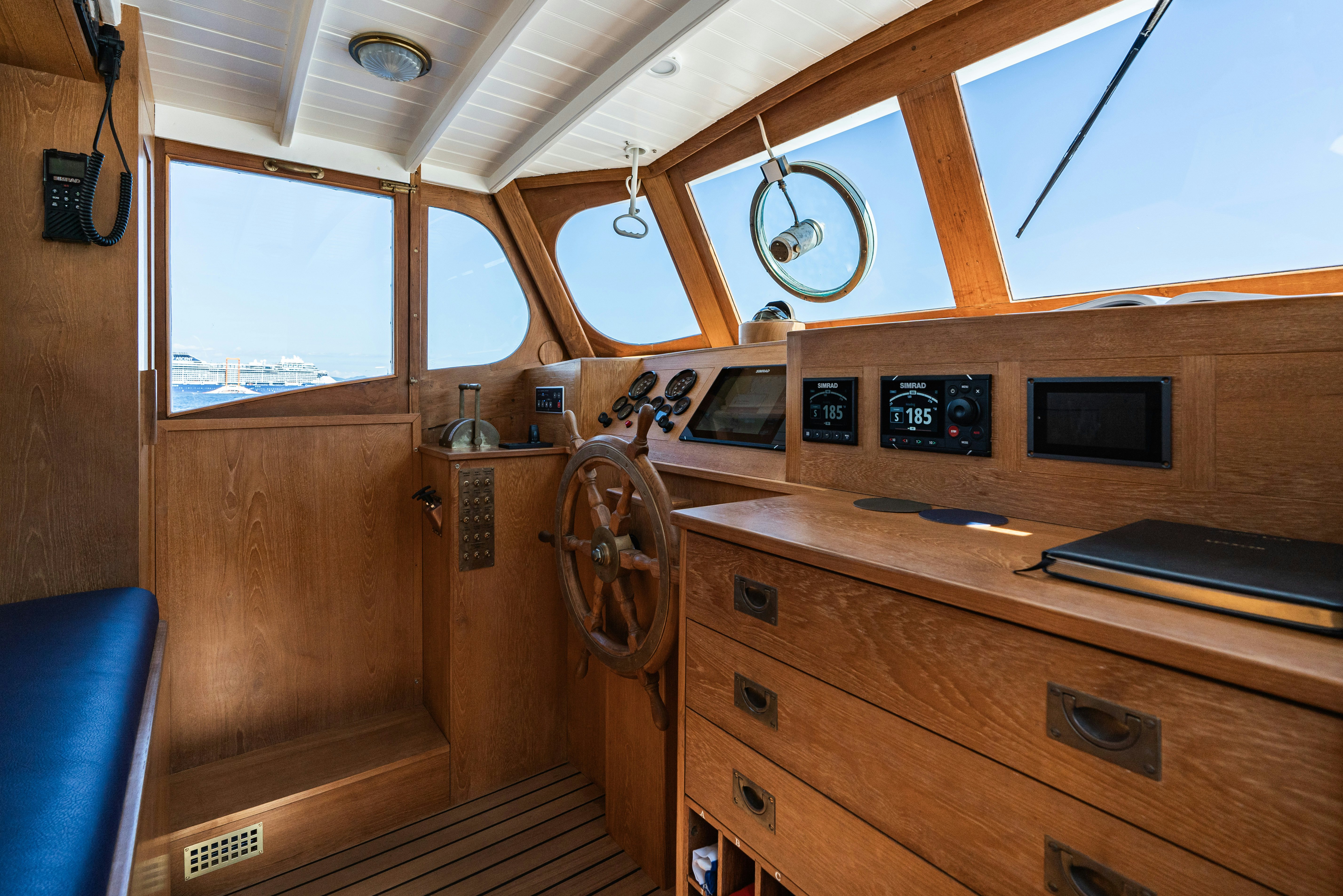 a wooden cabin with a wood paneled door and a window aboard SILVER LASS Yacht for Sale