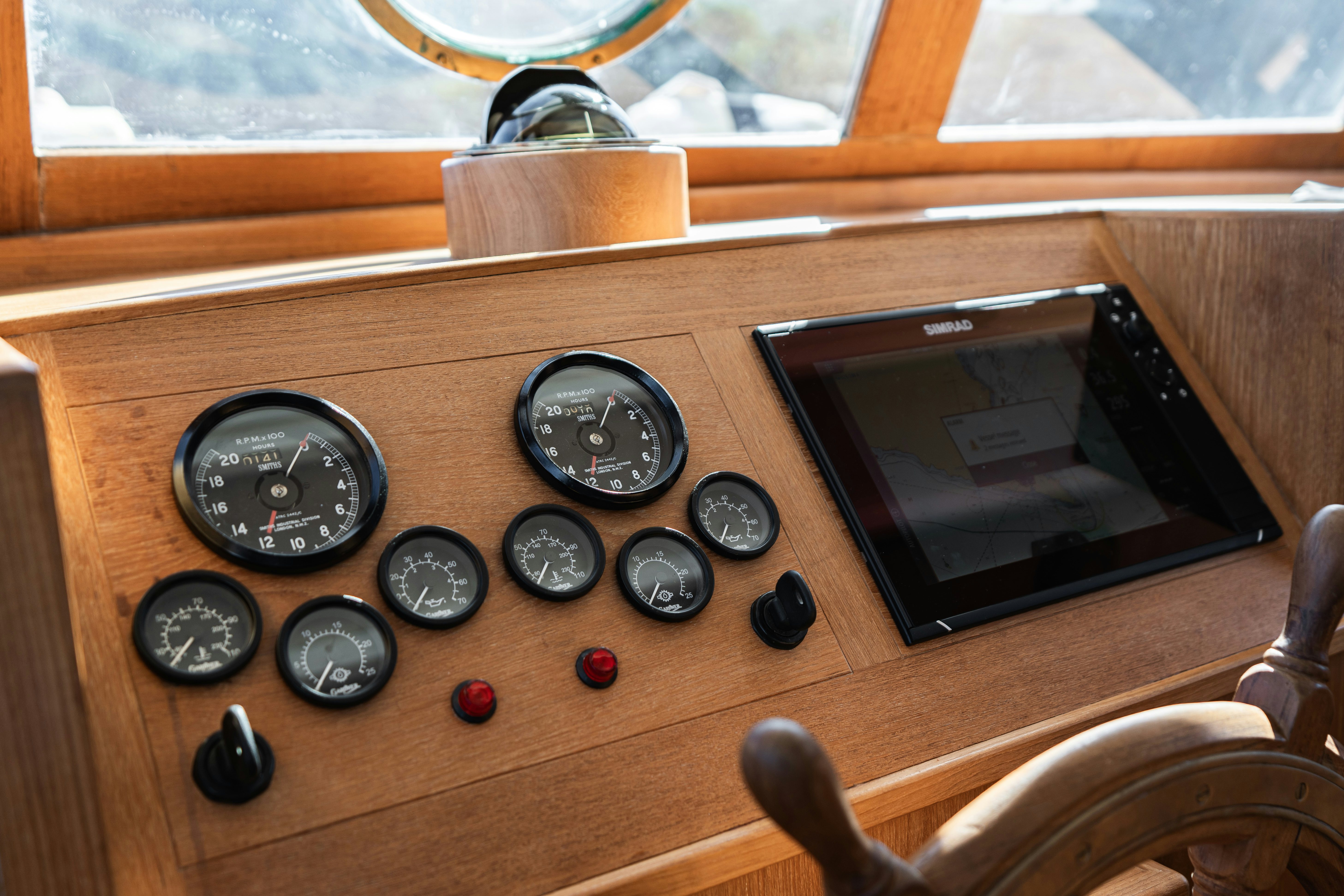 a wooden table with a television and dials on it aboard SILVER LASS Yacht for Sale