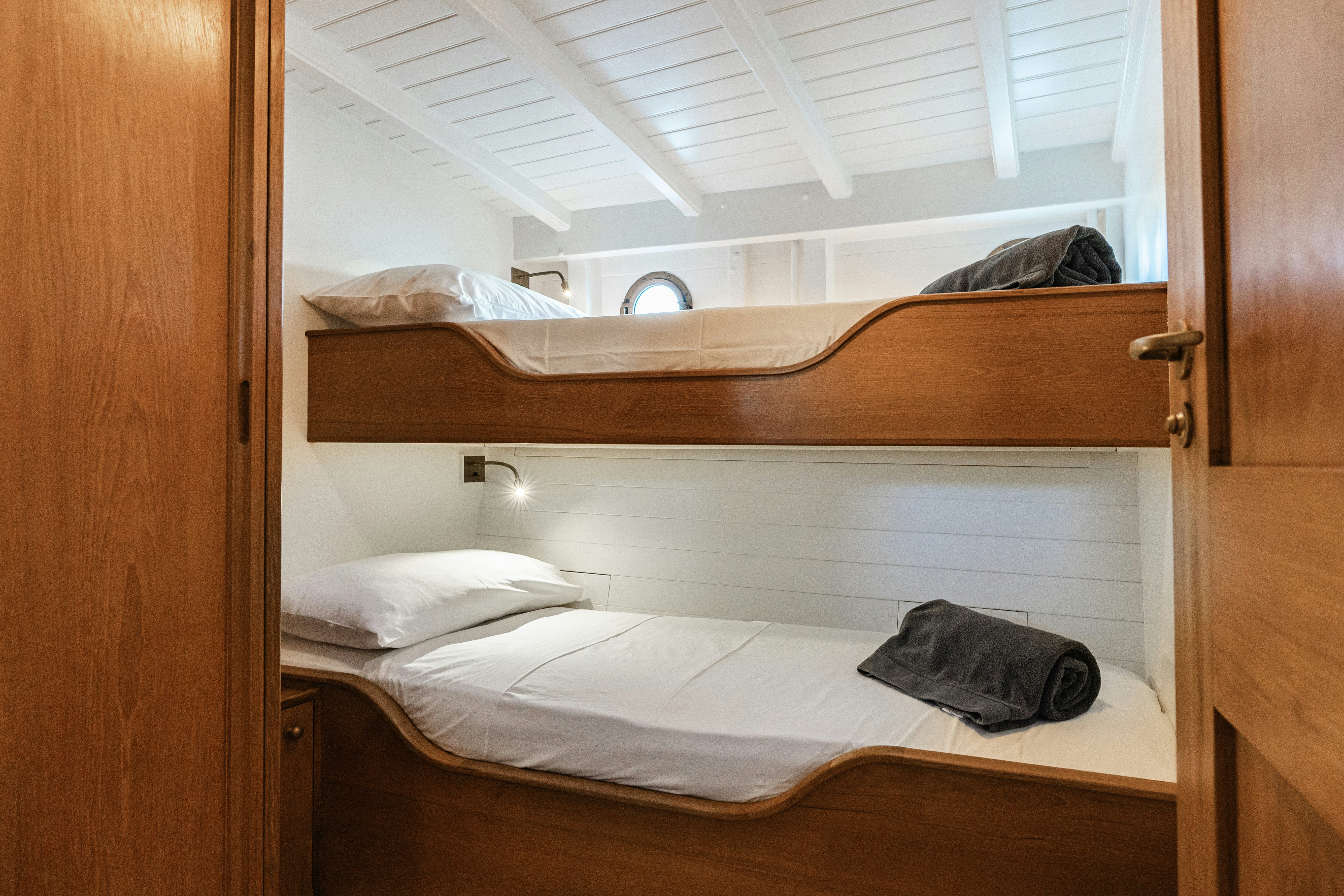 a bed with a wooden headboard aboard SILVER LASS Yacht for Sale