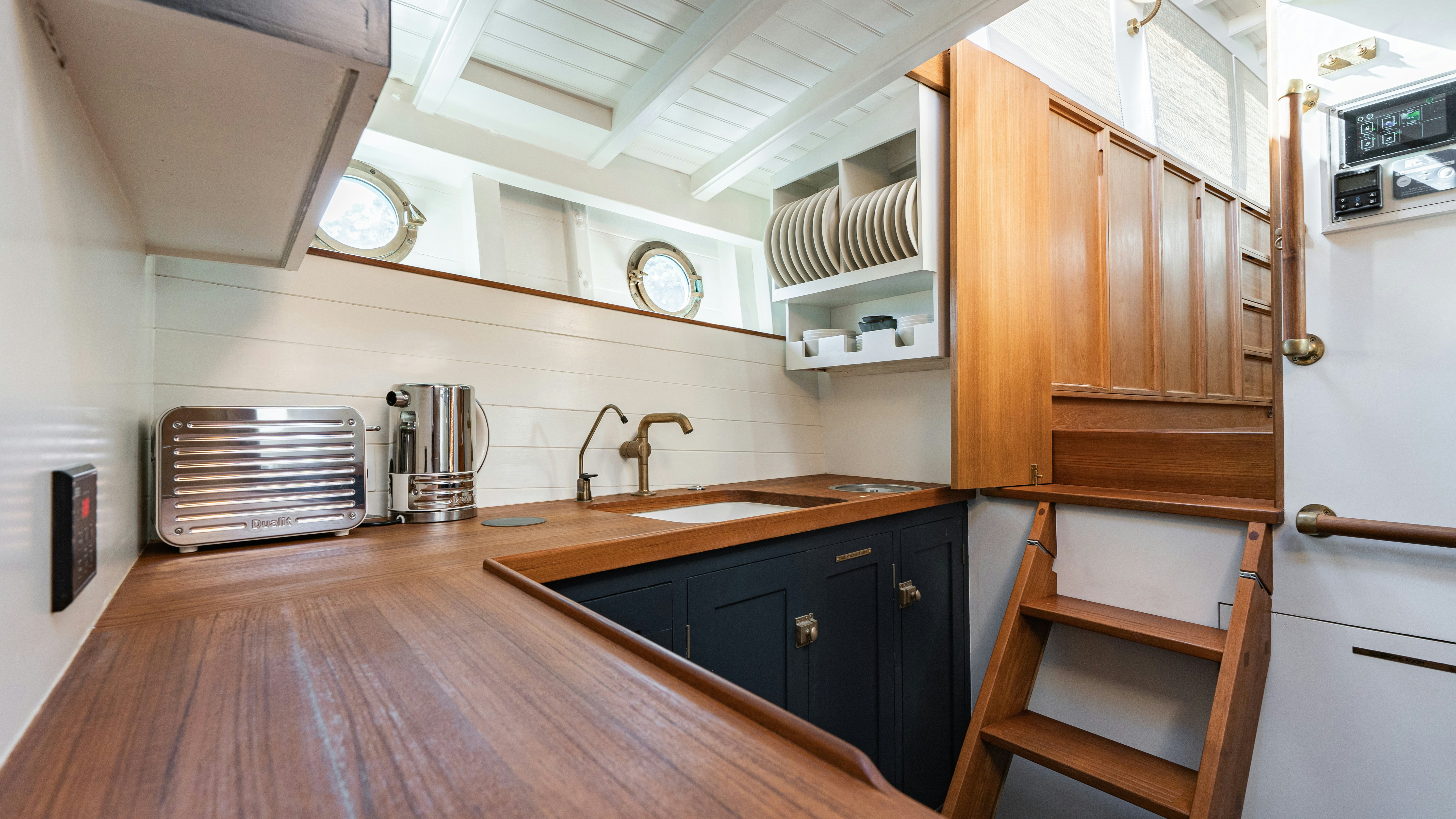 a kitchen with wooden cabinets aboard SILVER LASS Yacht for Sale