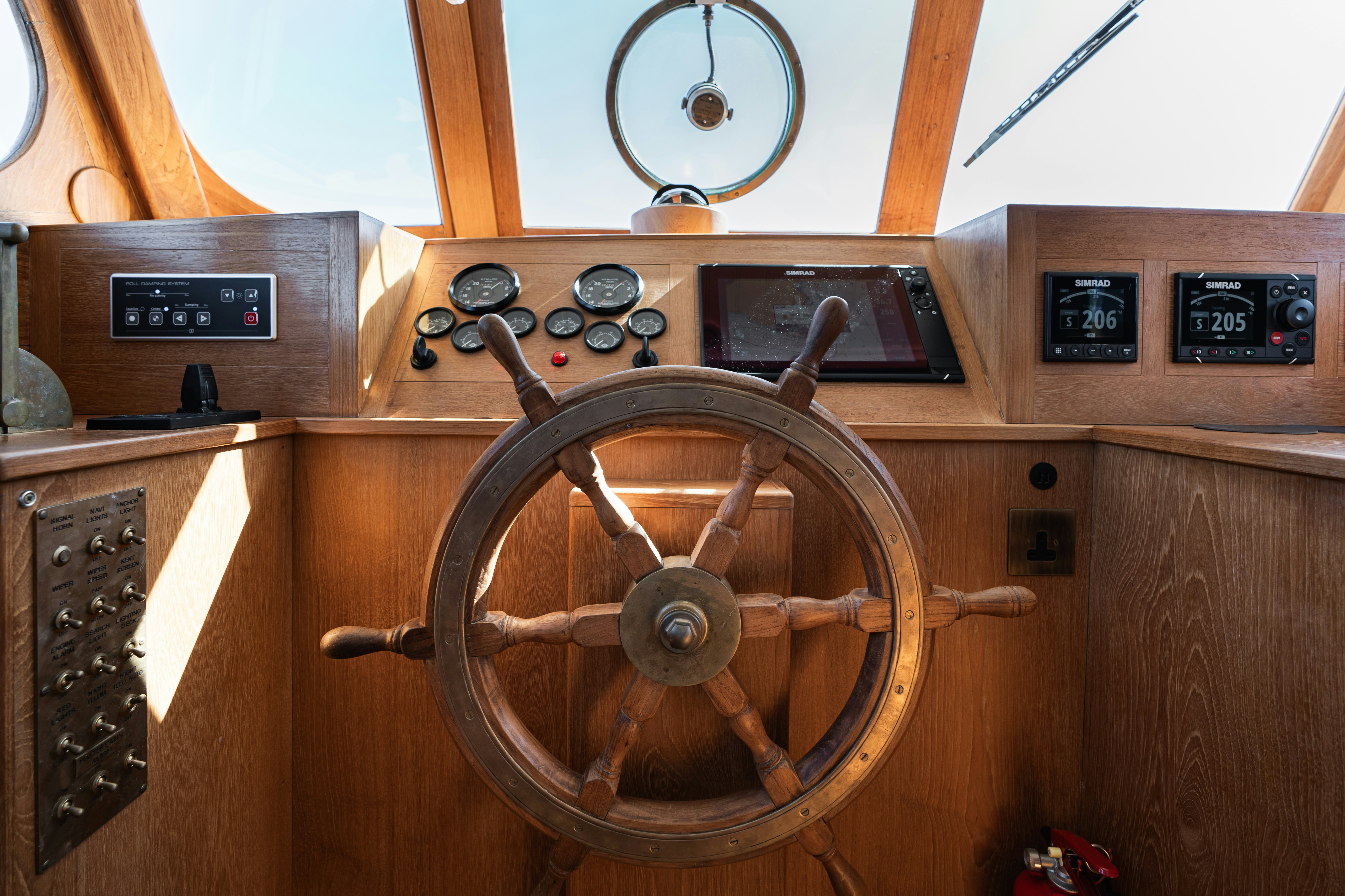 a wooden wheel with a wooden surface aboard SILVER LASS Yacht for Sale