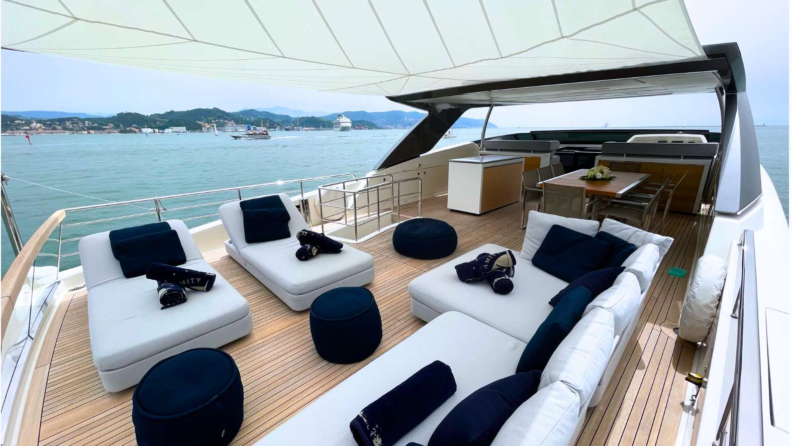 a large white lounge chair on a deck overlooking a large body of water aboard FRANCAMARINA Yacht for Charter