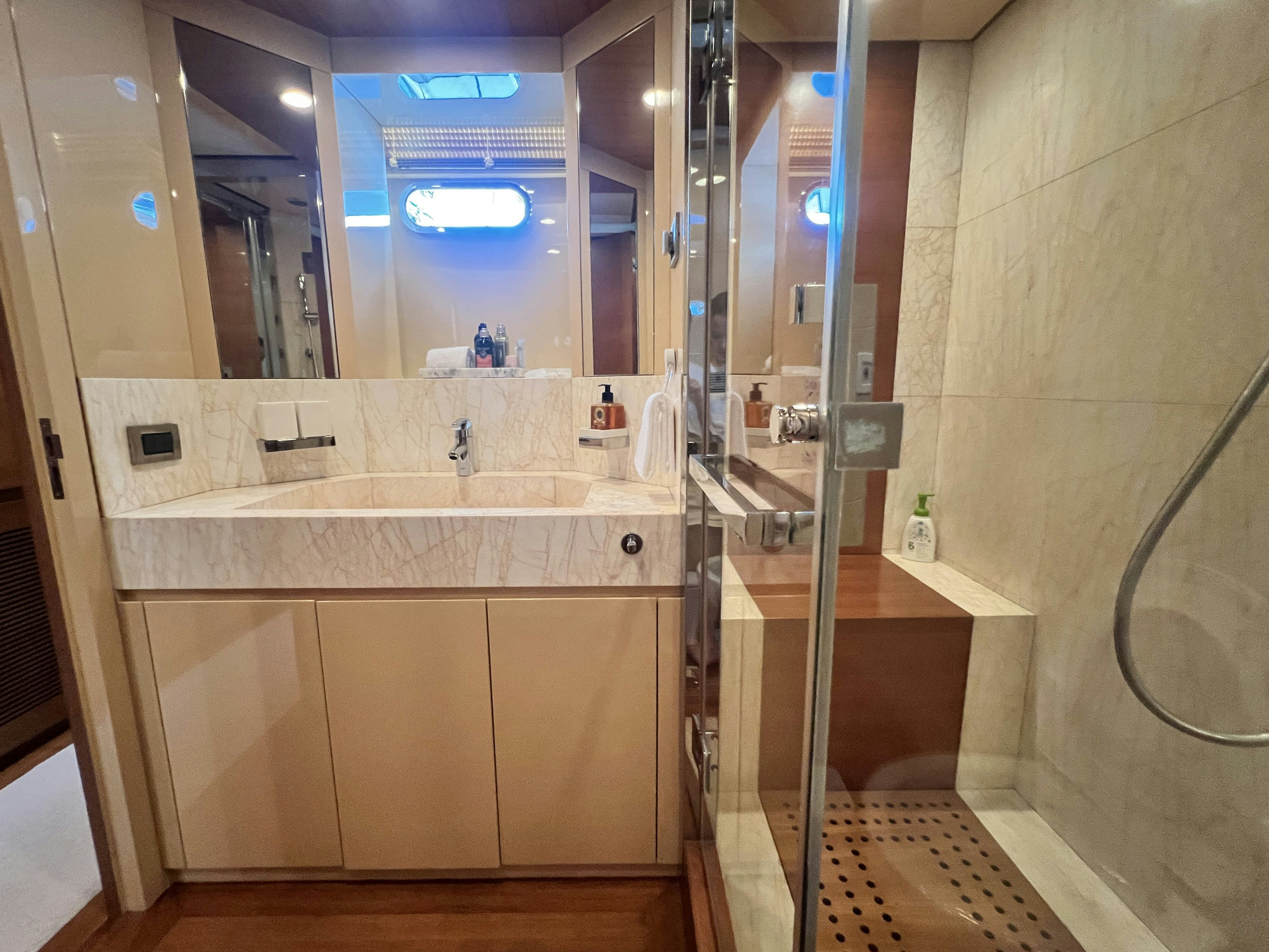 a bathroom with a large mirror aboard SUNRISE Yacht for Sale