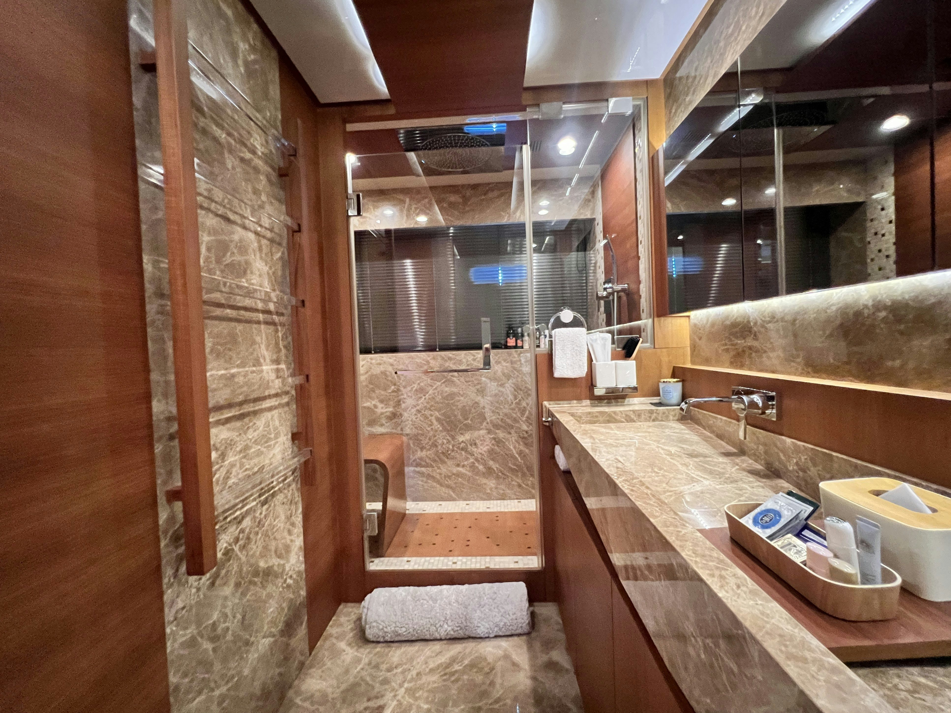 a bathroom with a countertop sink and a mirror aboard SUNRISE Yacht for Sale