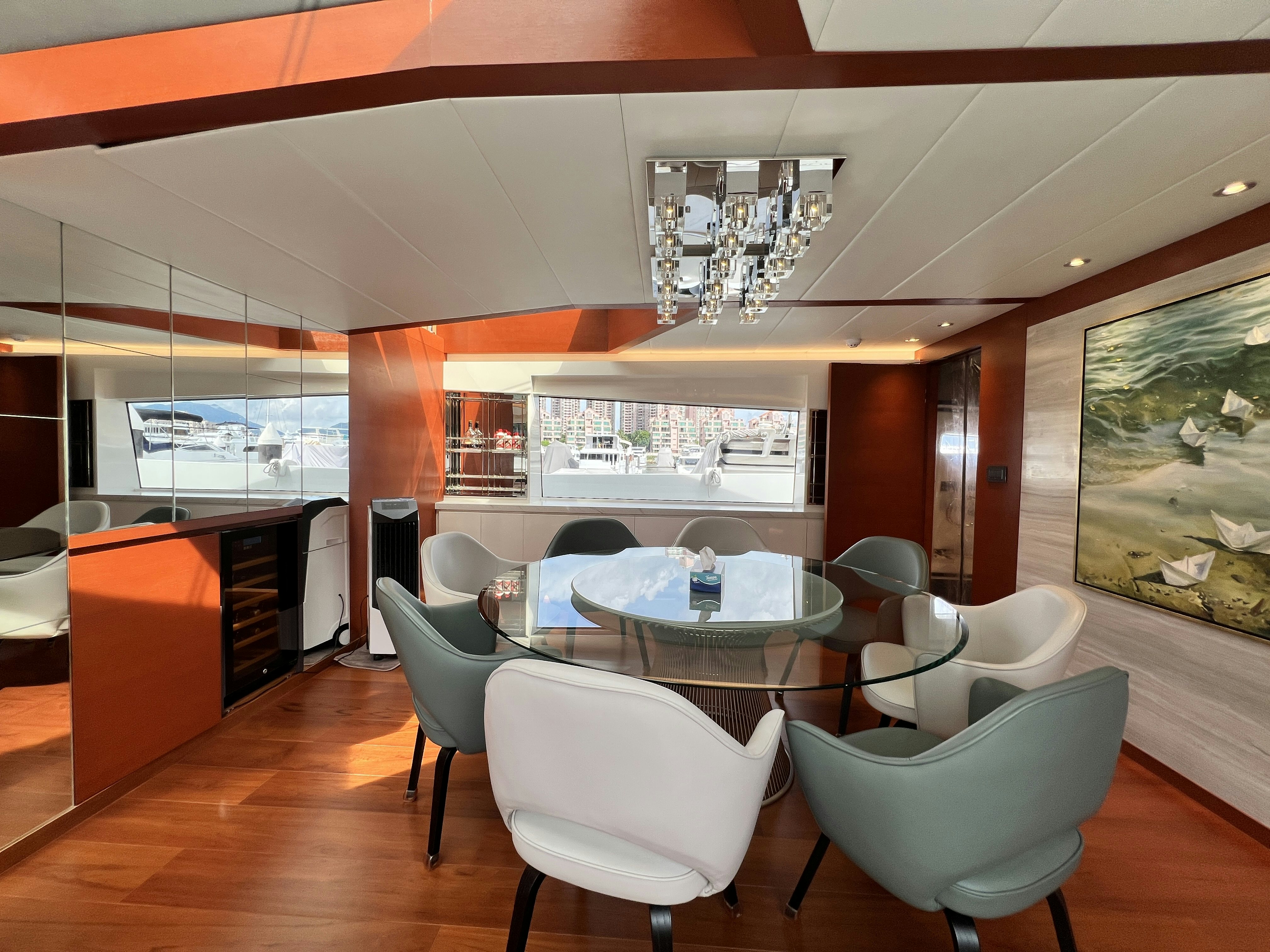a room with a table chairs and a chandelier aboard SUNRISE Yacht for Sale