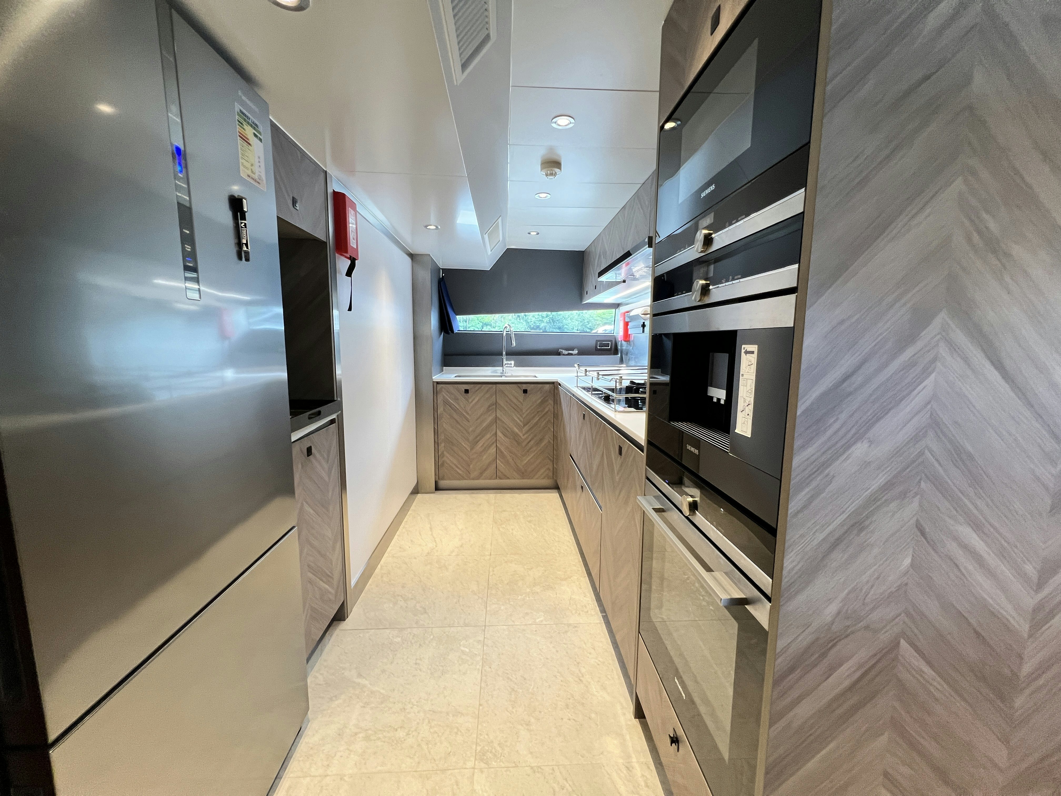 a kitchen with a fridge and oven aboard SUNRISE Yacht for Sale