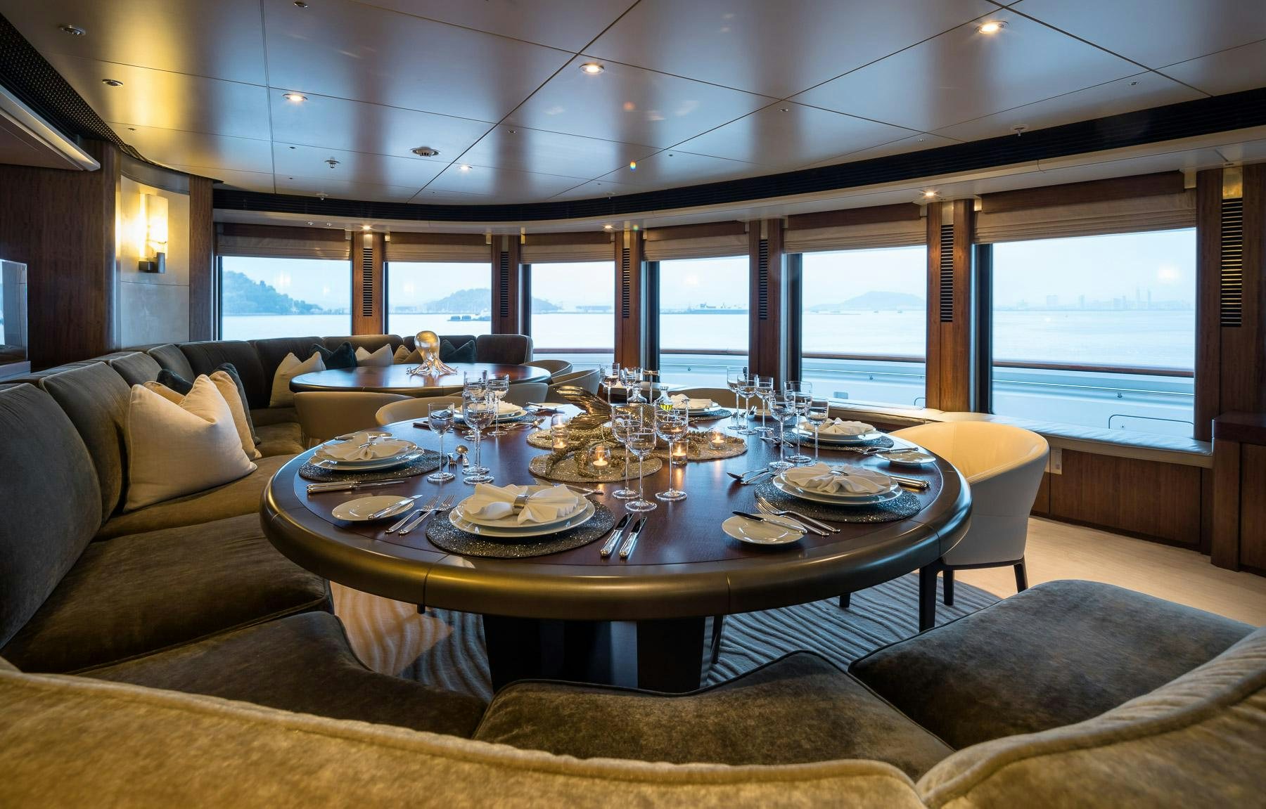 a dining table in a living room aboard OCTOPUS Yacht for Charter
