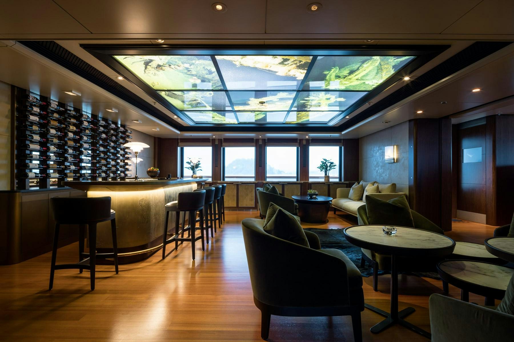a room with a table chairs and a large window aboard OCTOPUS Yacht for Charter