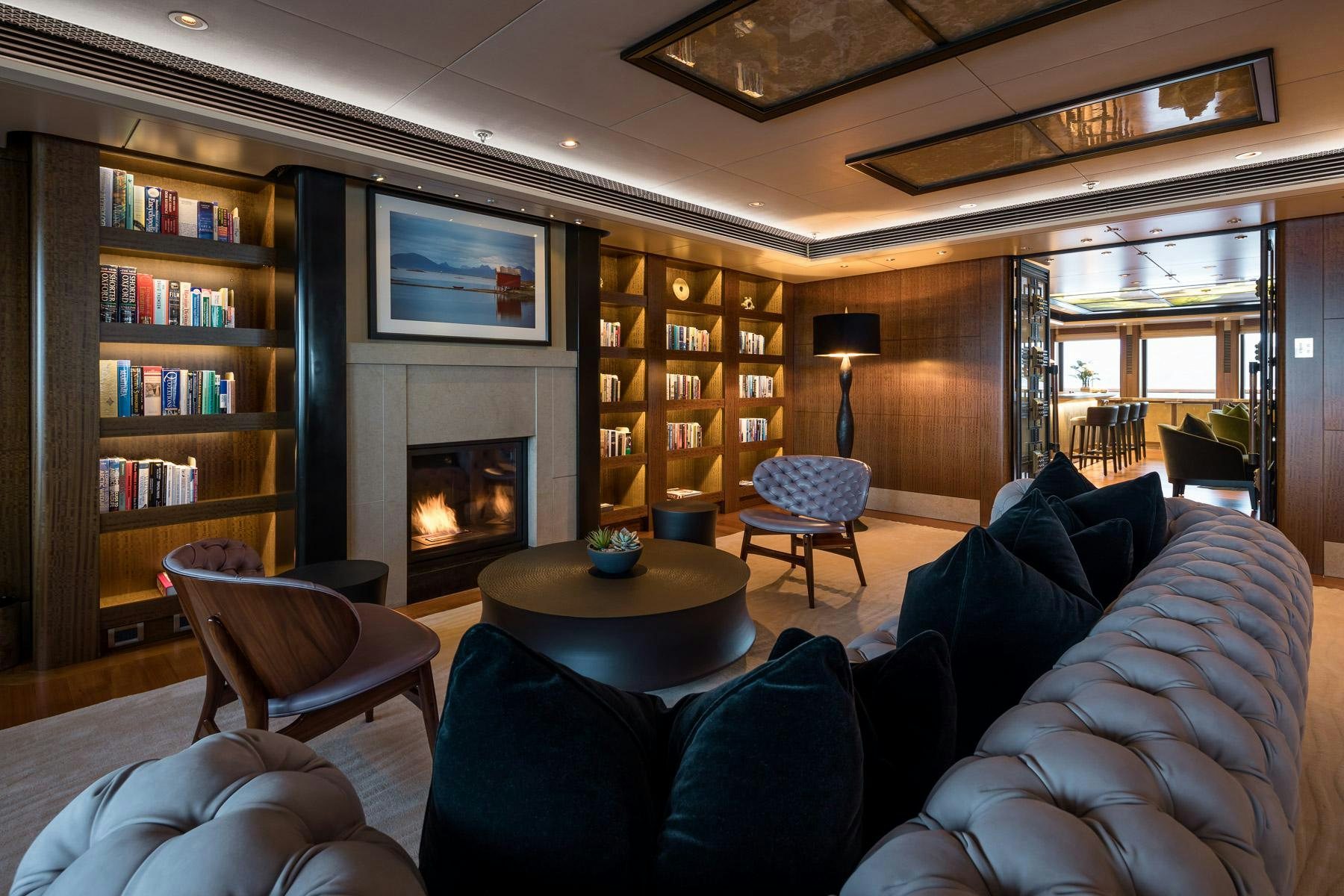 a living room with a fireplace aboard OCTOPUS Yacht for Charter