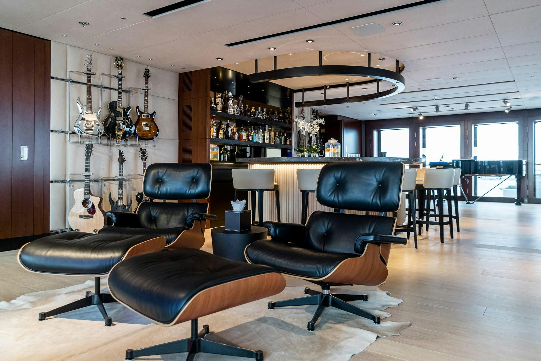 a room with a couch and a guitar aboard OCTOPUS Yacht for Charter