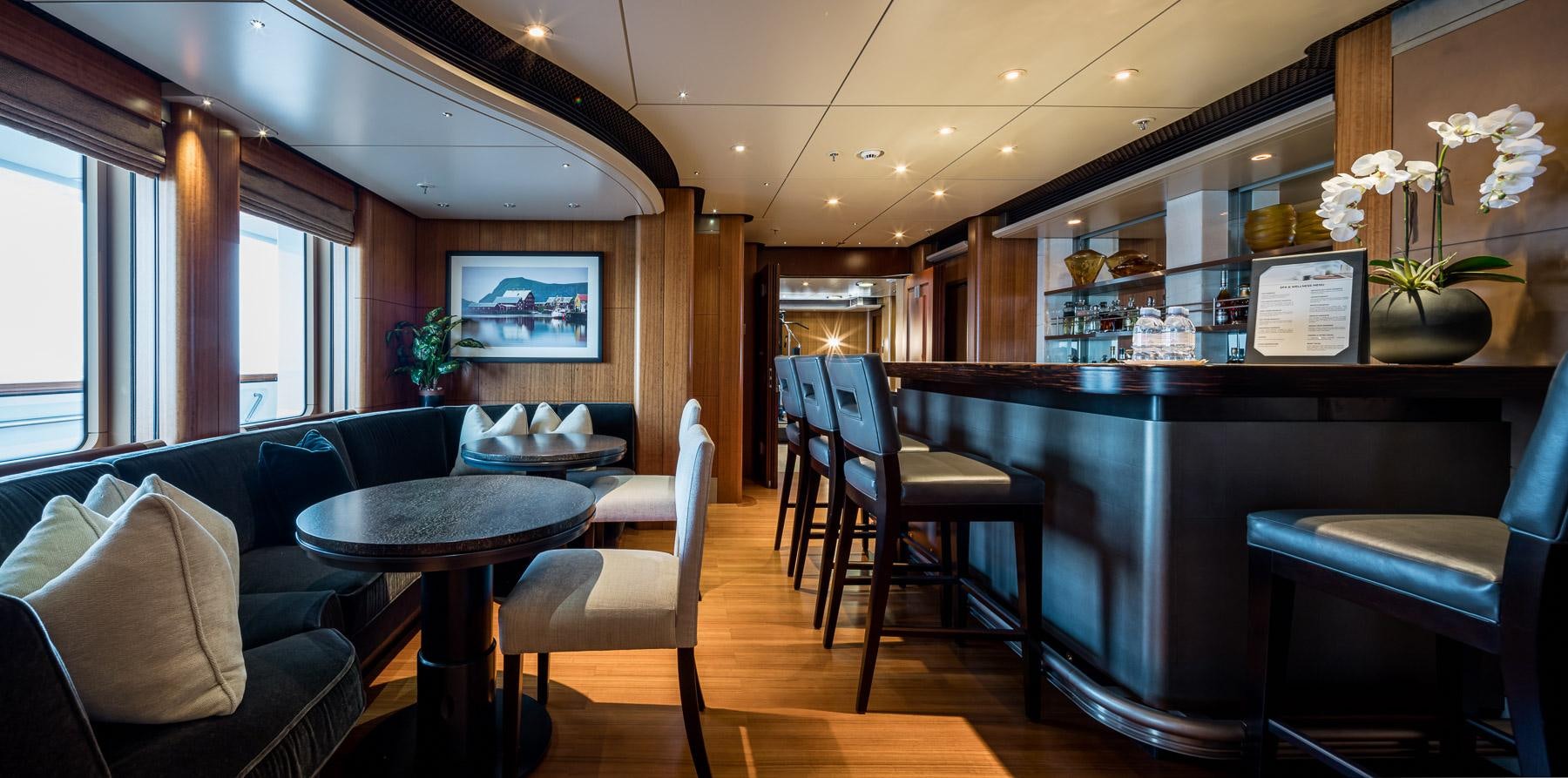a room with a couch and a table and chairs aboard OCTOPUS Yacht for Charter