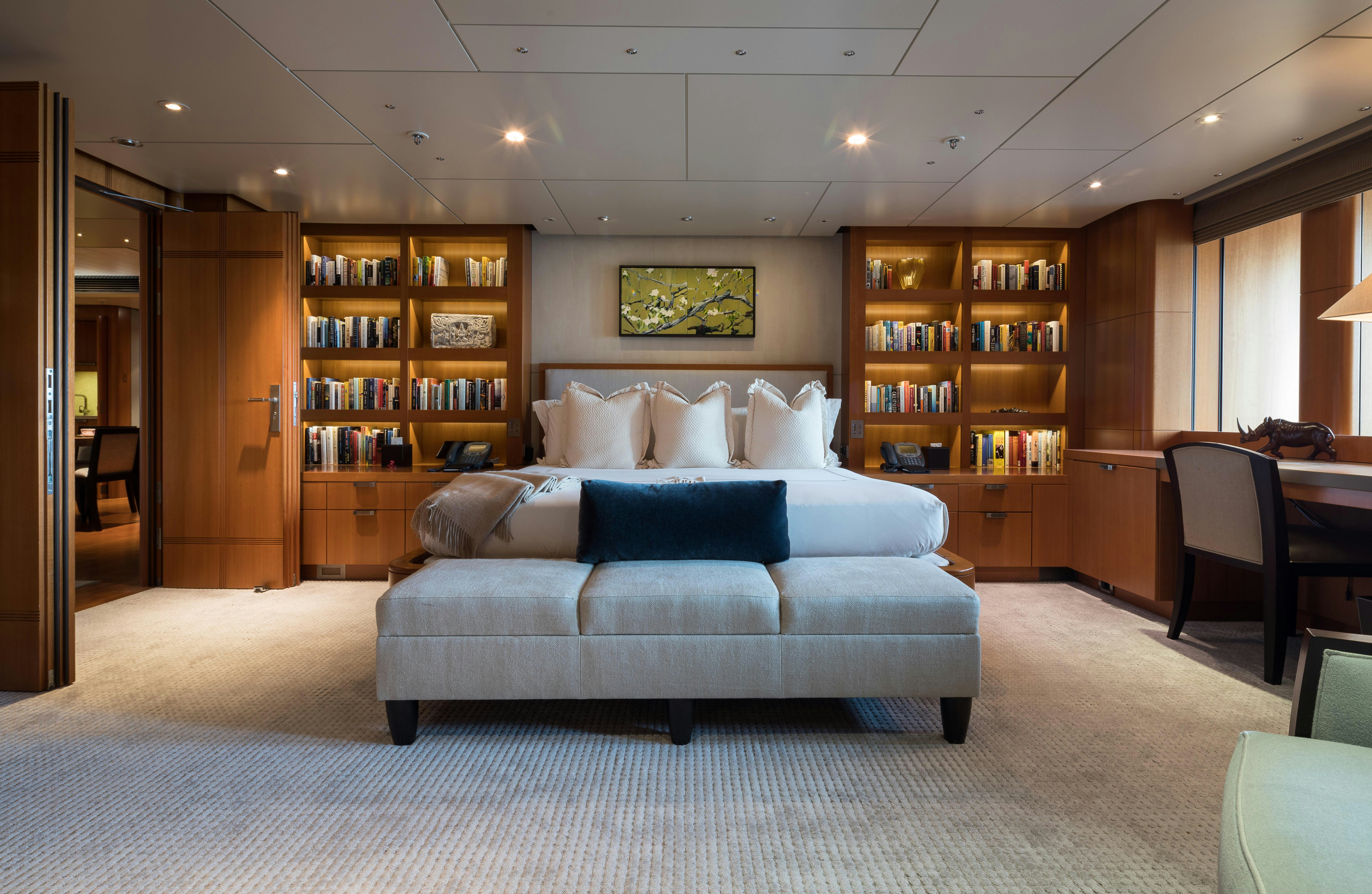 a living room with a couch and bookshelves aboard OCTOPUS Yacht for Charter