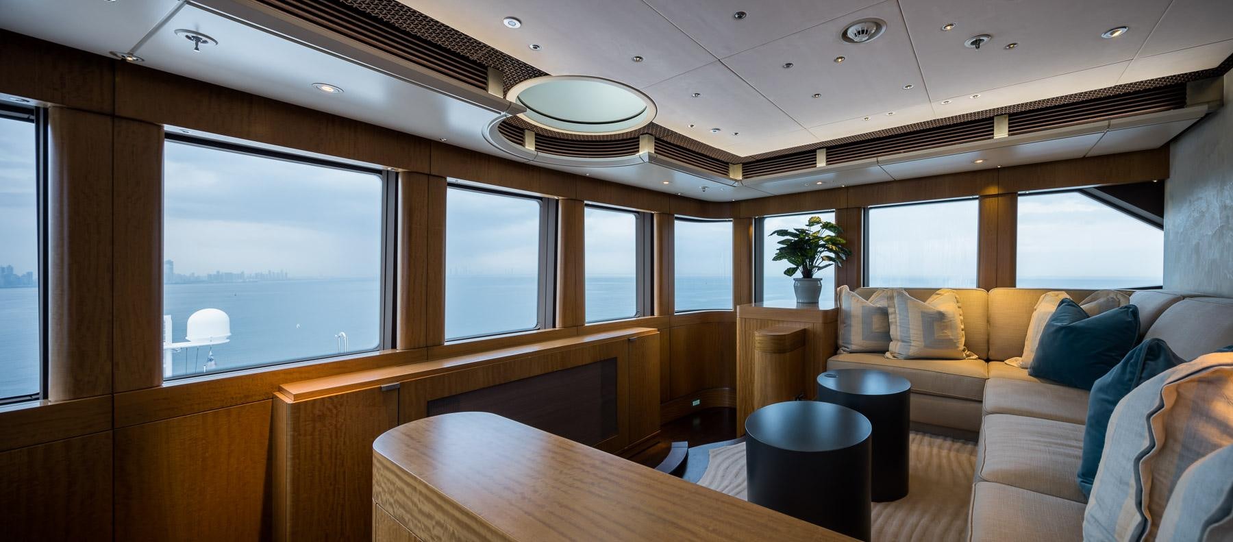 a room with a couch and a table and a window aboard OCTOPUS Yacht for Charter