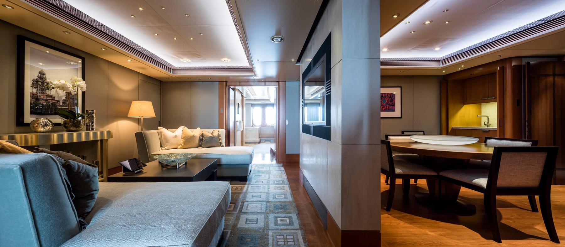 a room with a couch and a table and a bed aboard OCTOPUS Yacht for Charter