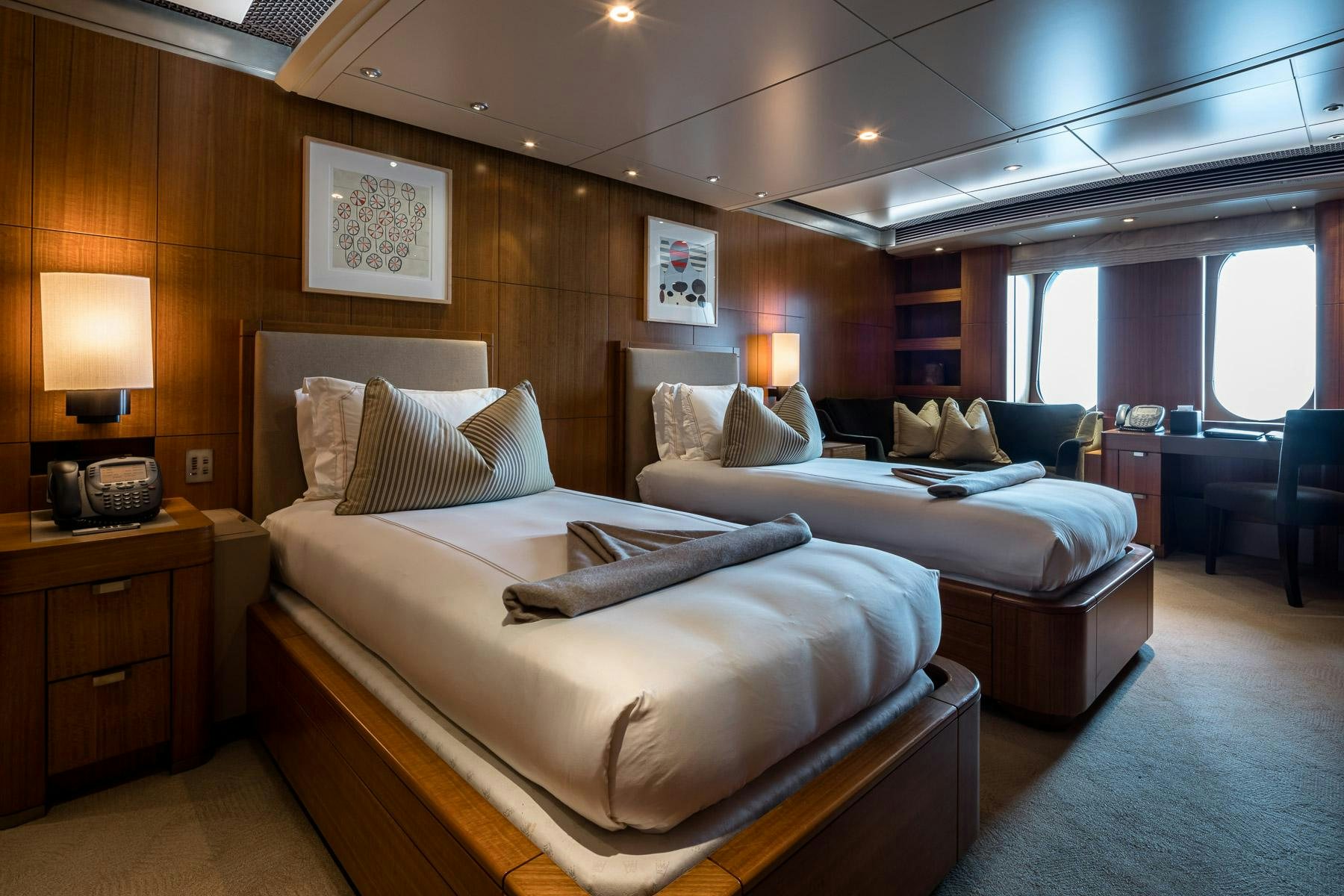 a couple of beds in a hotel room aboard OCTOPUS Yacht for Charter