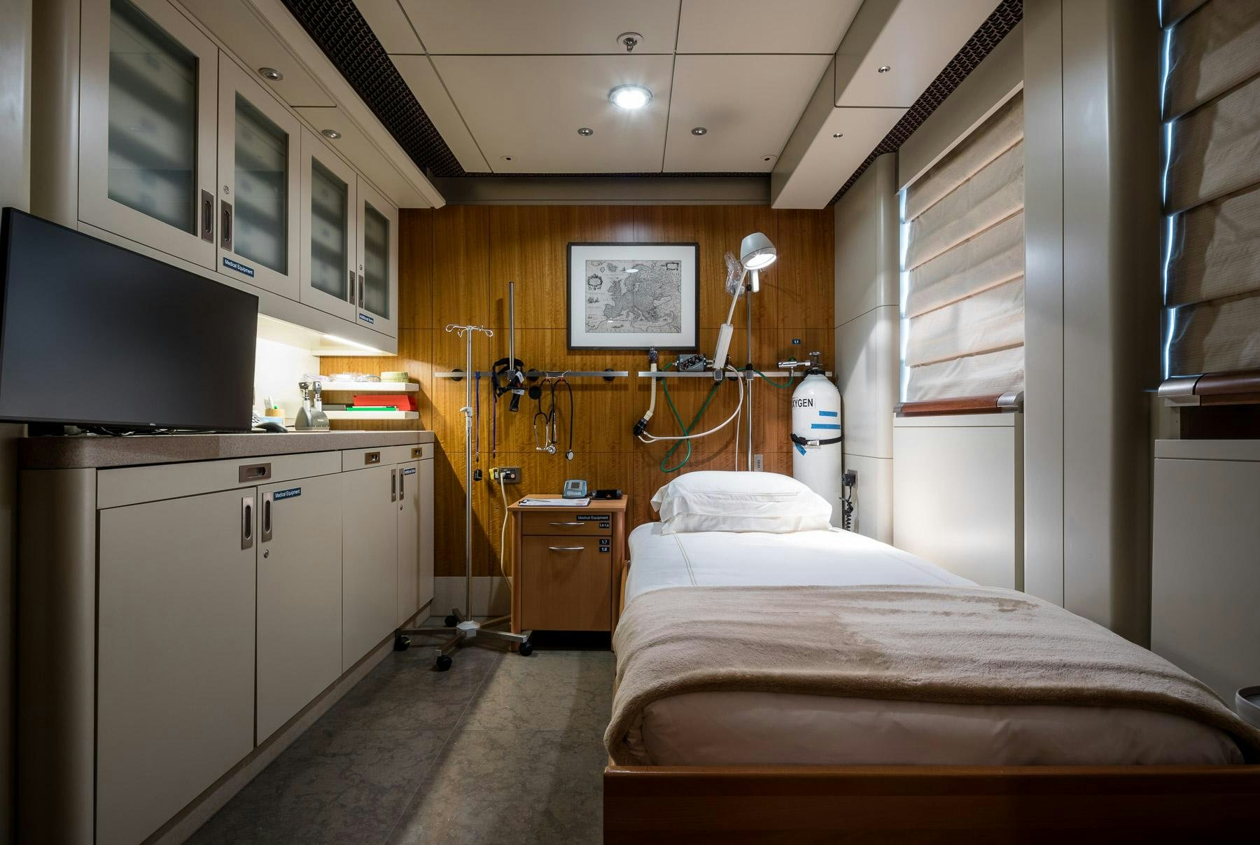 a room with a bed and a tv aboard OCTOPUS Yacht for Charter