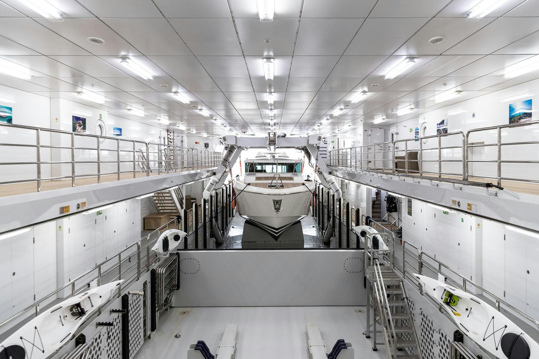 a large white vehicle in a factory aboard OCTOPUS Yacht for Charter
