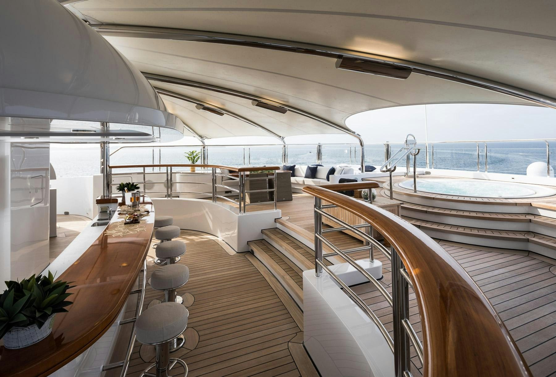a room with a deck and a view of the water aboard OCTOPUS Yacht for Charter
