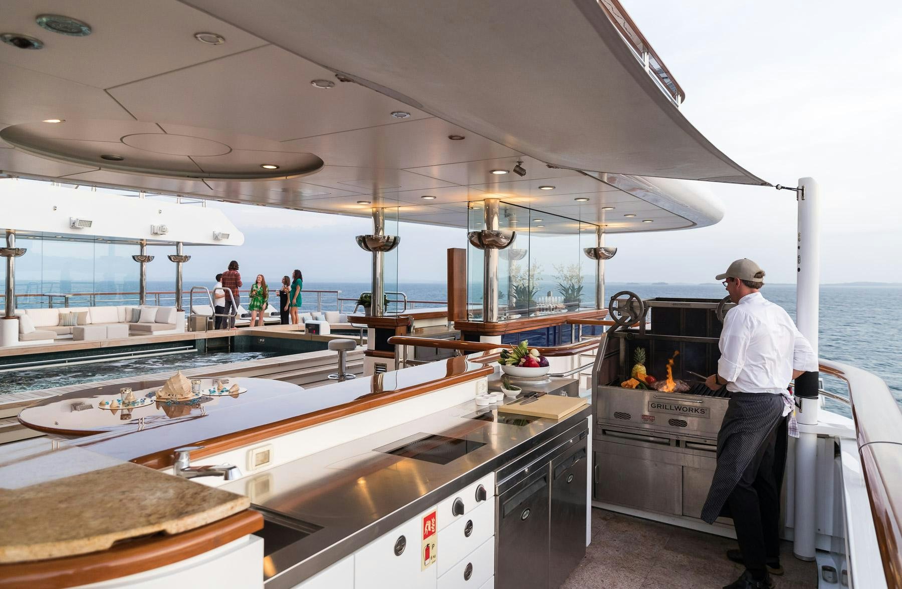 a person standing in a kitchen aboard OCTOPUS Yacht for Charter