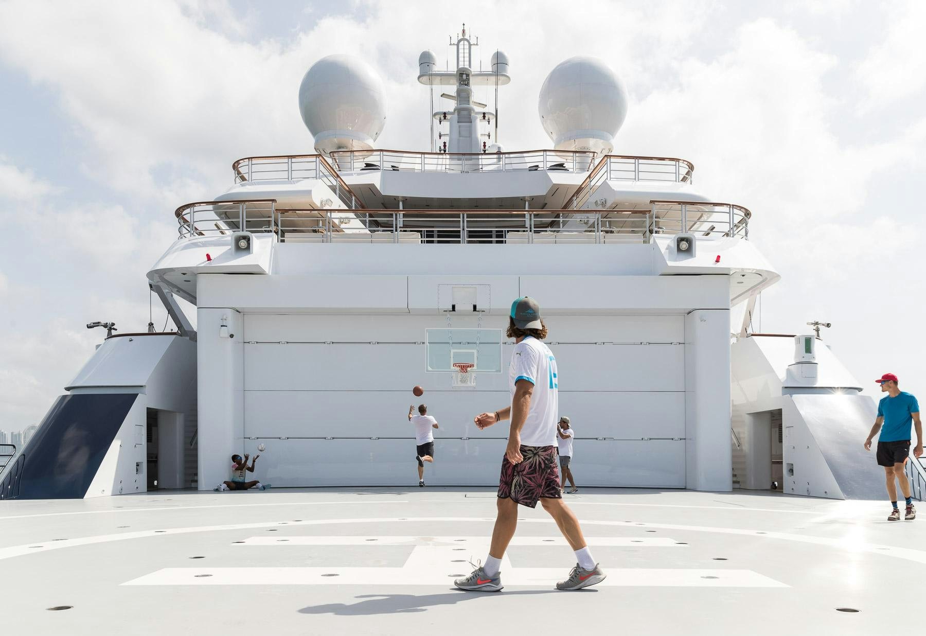 a group of people walking on a ship aboard OCTOPUS Yacht for Charter