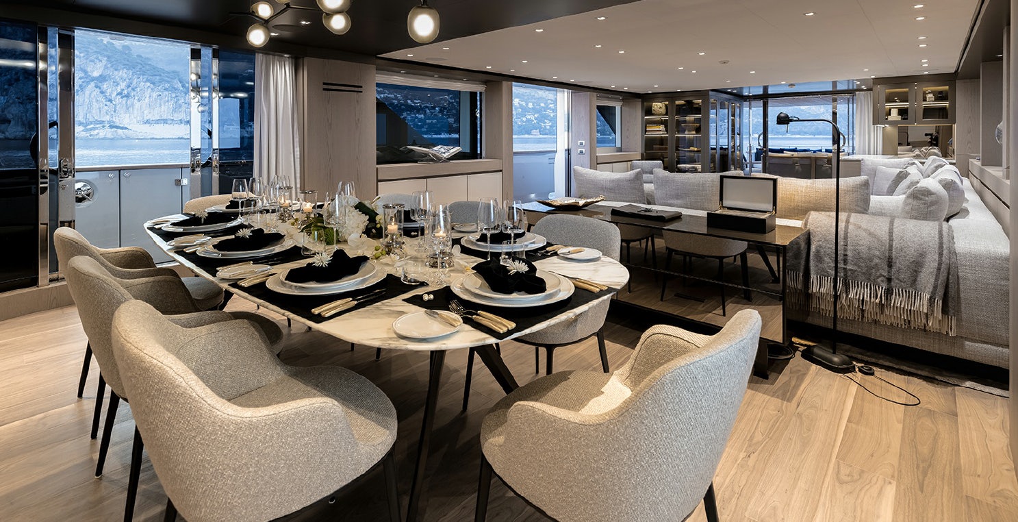 a large room with a table and chairs aboard LES BRUXELLOIS Yacht for Charter
