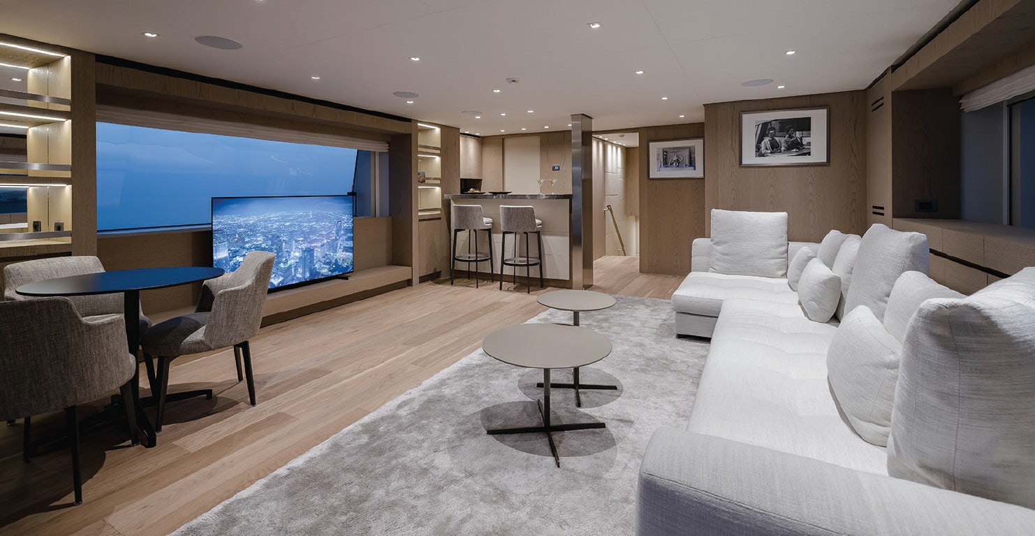 a living room with a large screen aboard LES BRUXELLOIS Yacht for Charter