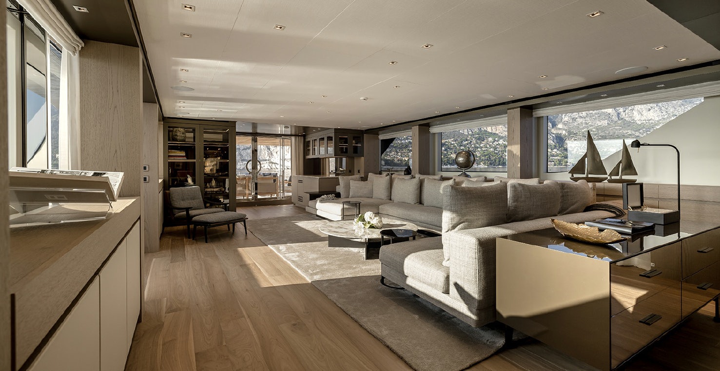 a large living room with a large window aboard LES BRUXELLOIS Yacht for Charter
