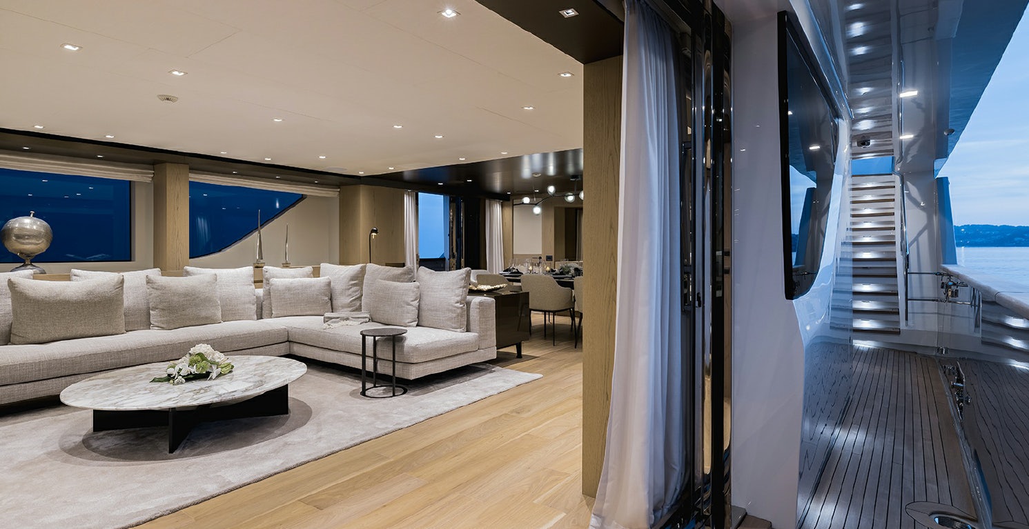 a living room with a large window aboard LES BRUXELLOIS Yacht for Charter